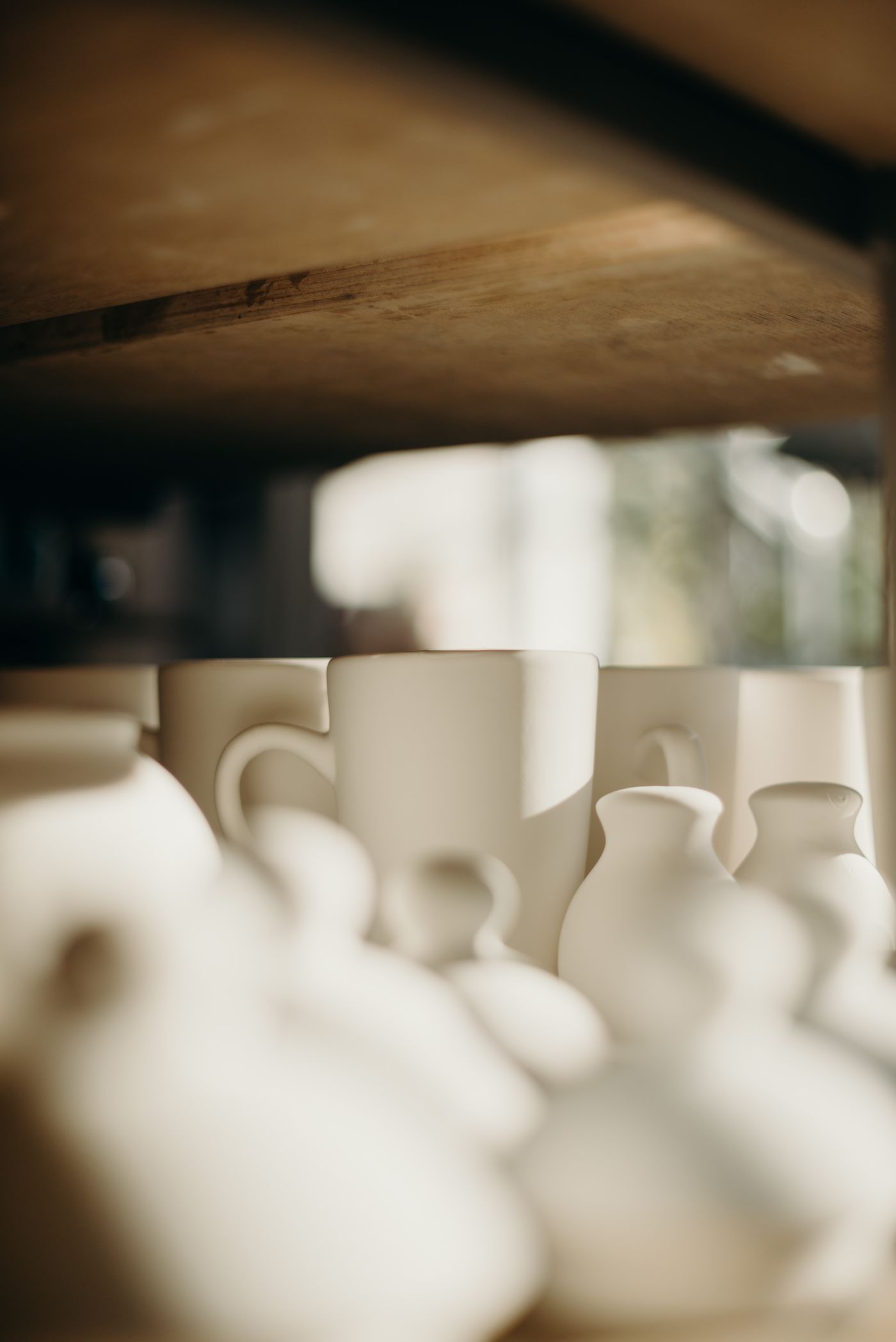Creamy handmade ceramic mugs and vases