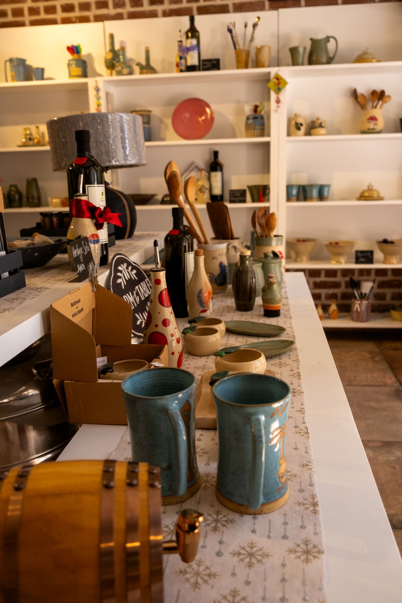 The curated interior of an artisan gift shop with pottery and decor