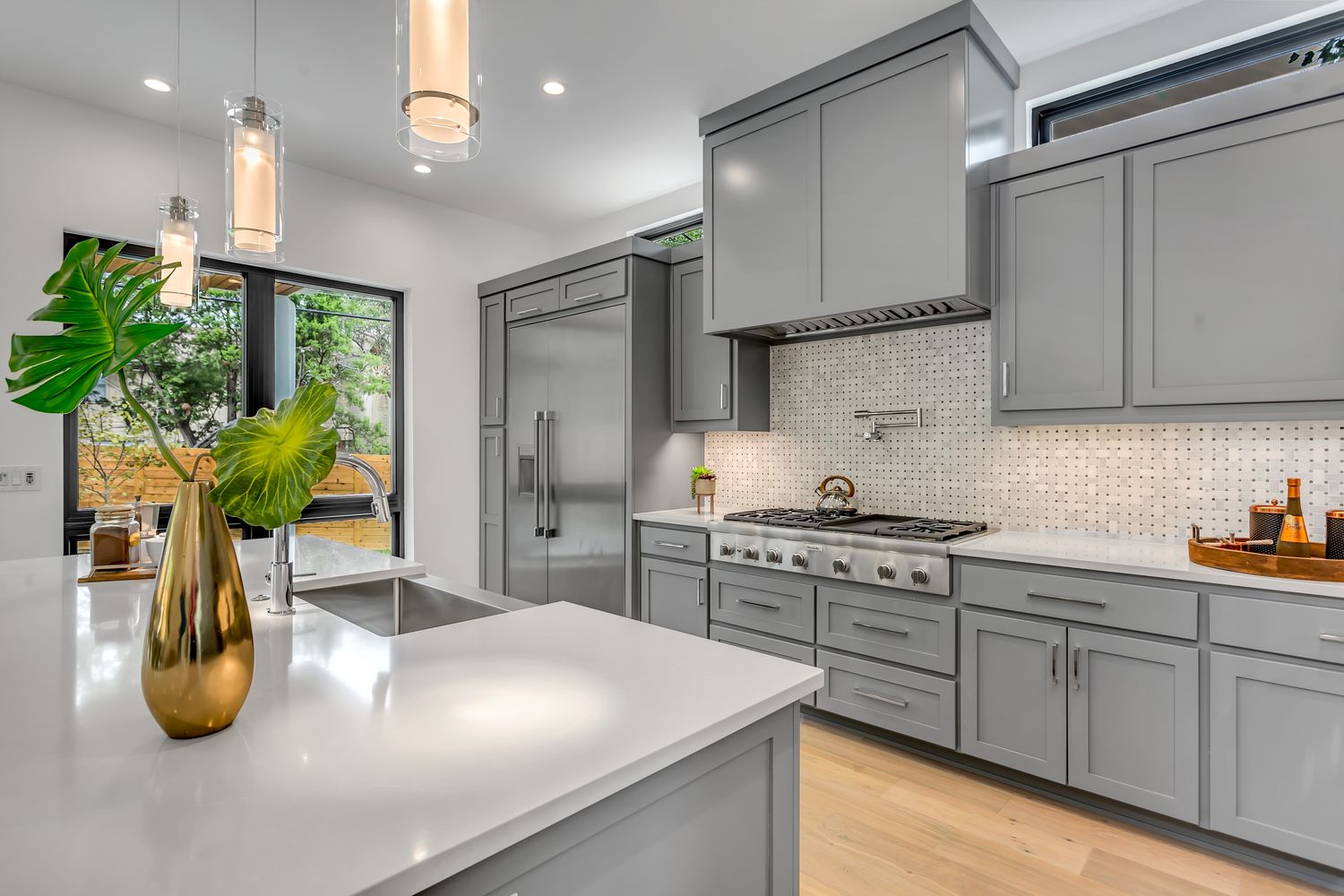 A bright renovated kitchen with stone counters and island