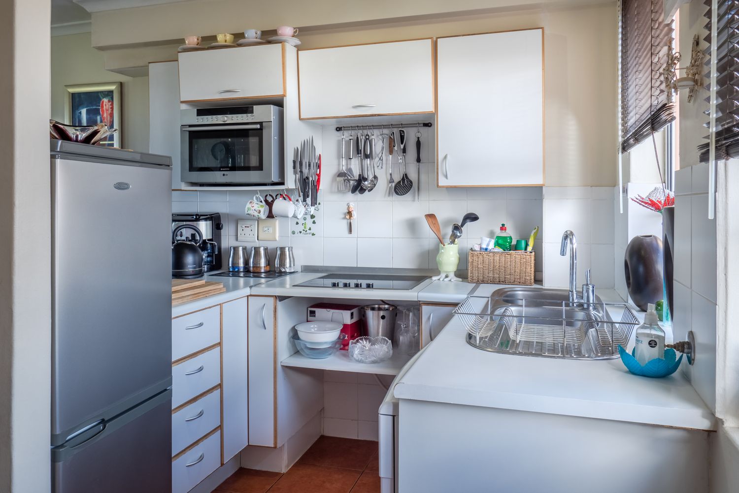 Renovated white kitchen with island and backsplash
