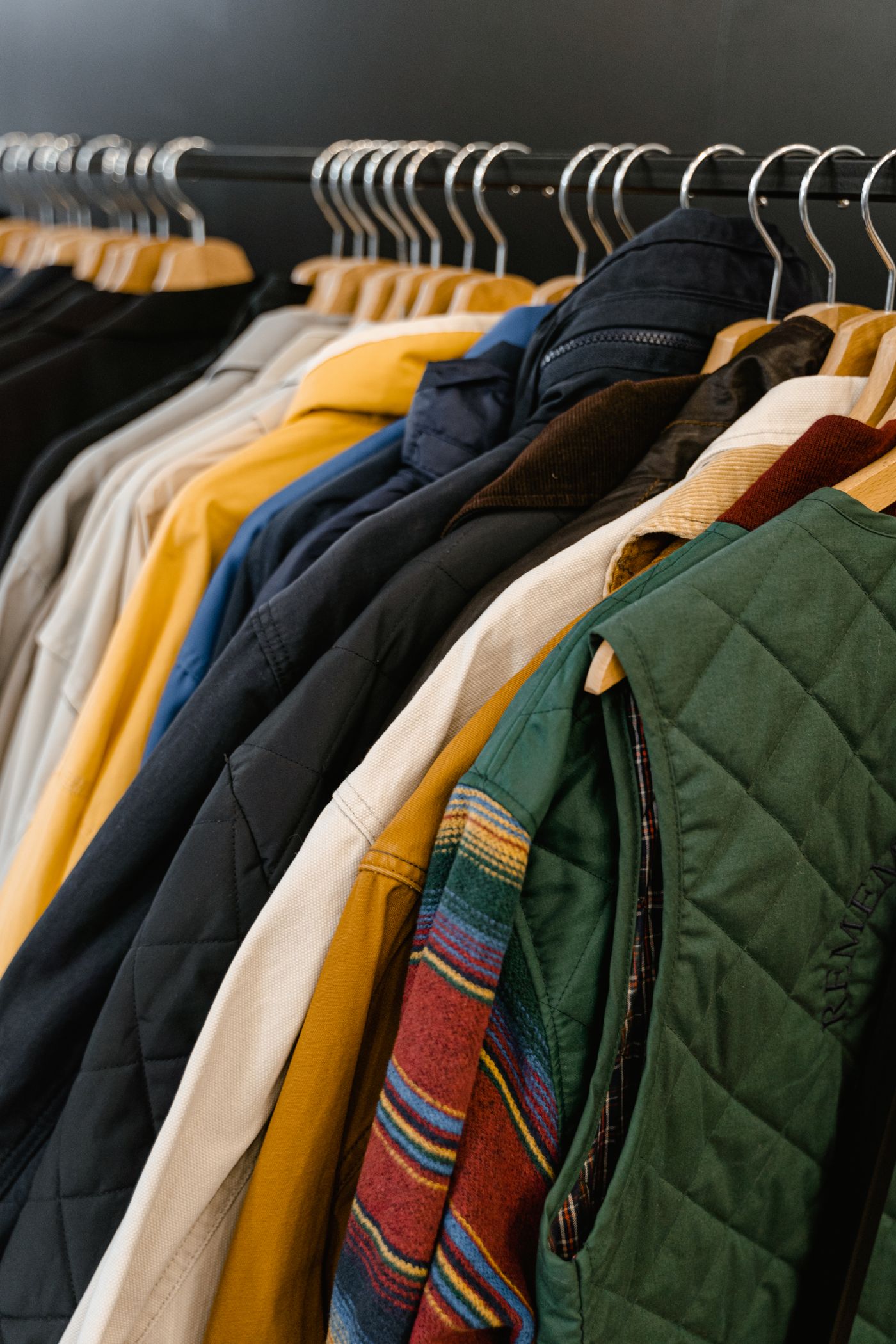 A rack of quilted jackets and richly coloured outerwear fabrics