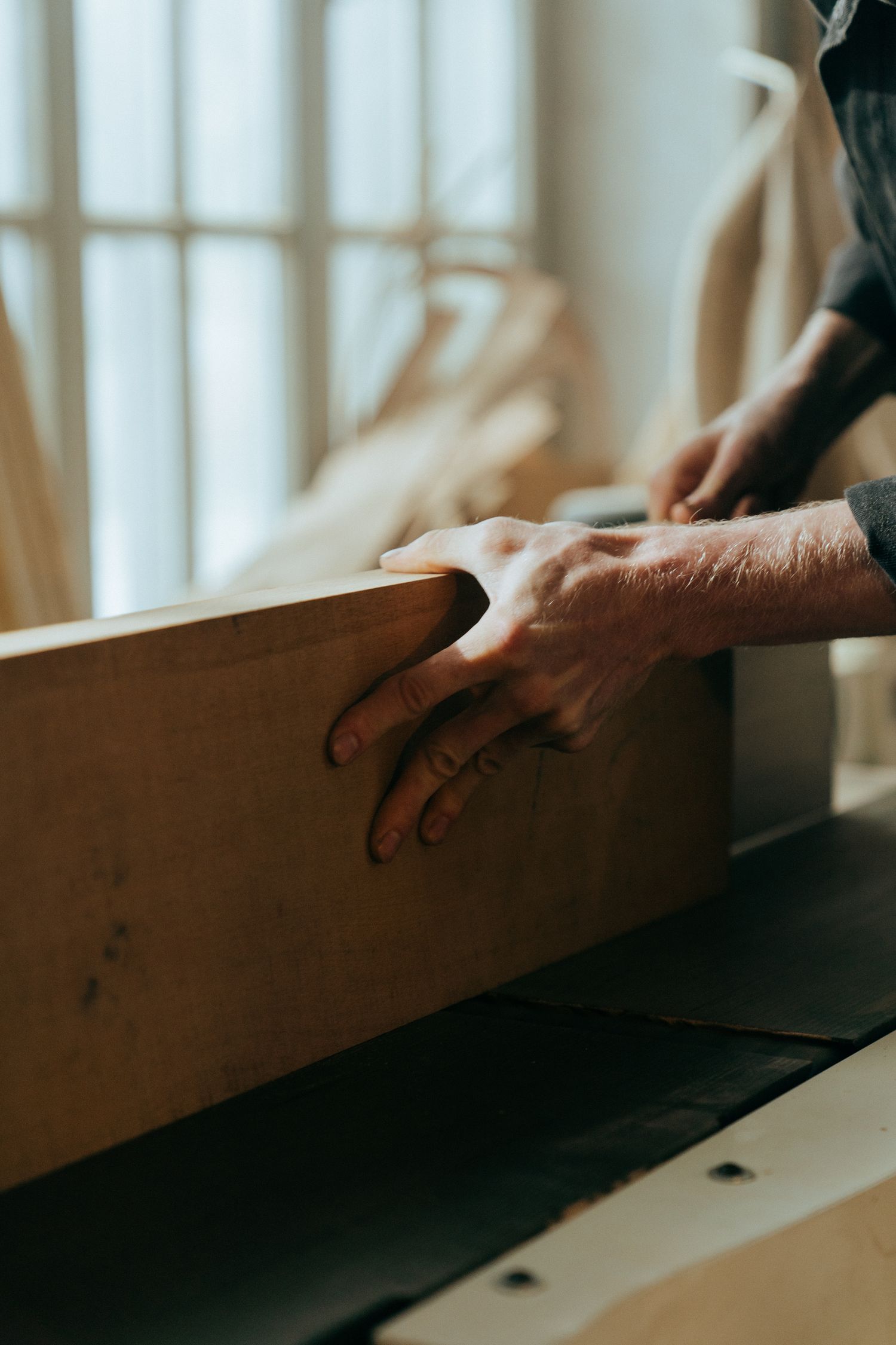 Hands holding a freshly finished board