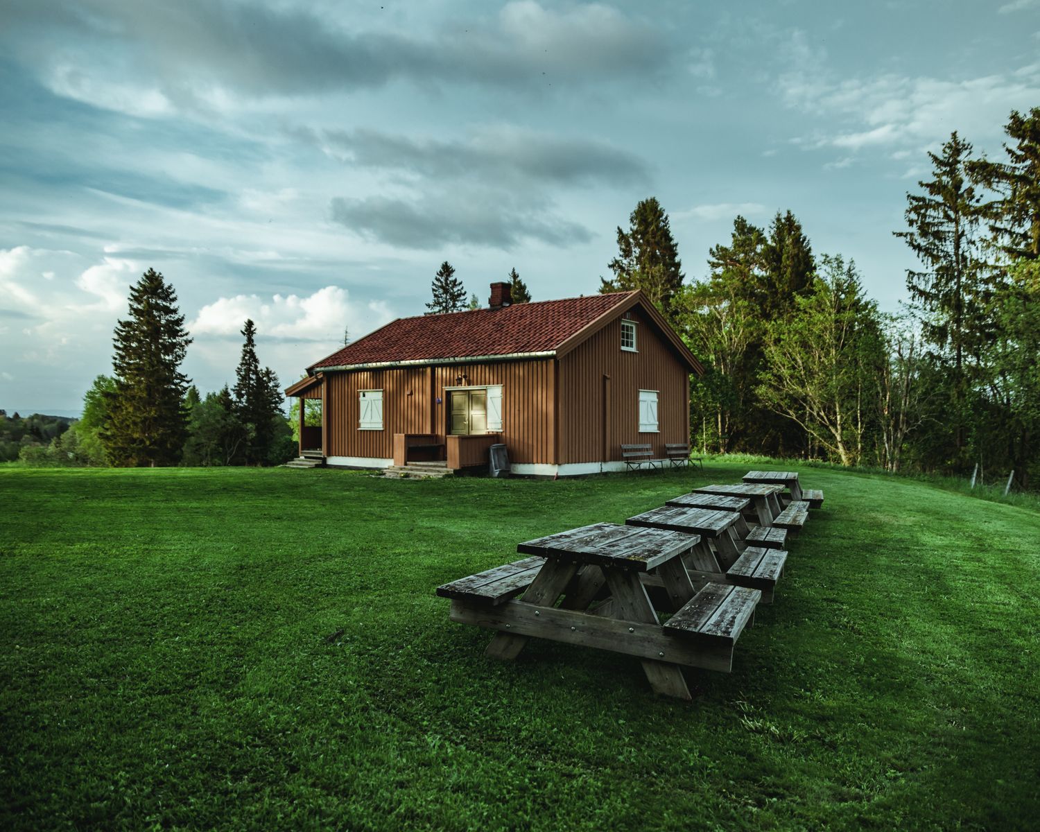 Home with a finished roof on a wide lawn