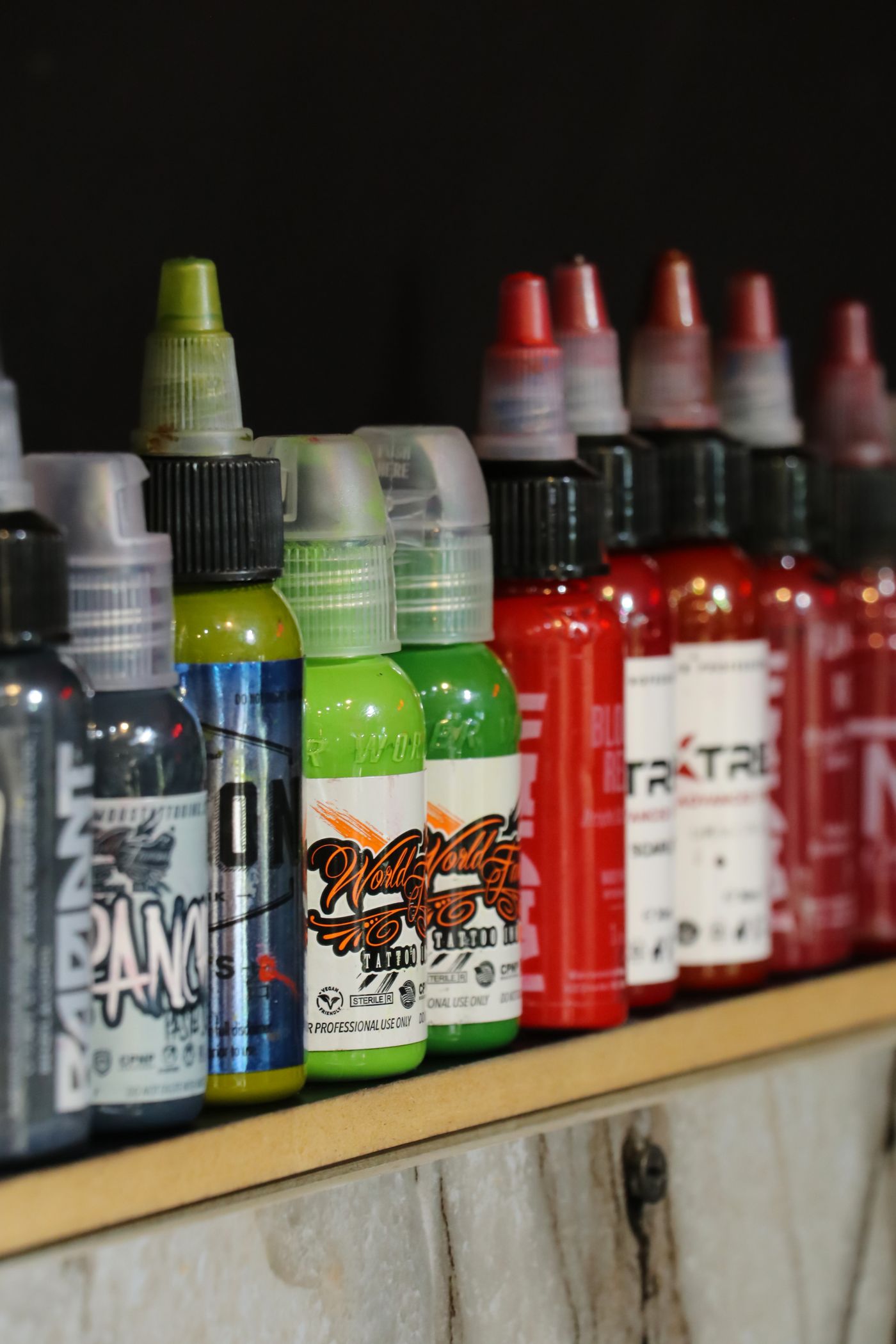 Tattoo ink bottles on the studio shelf