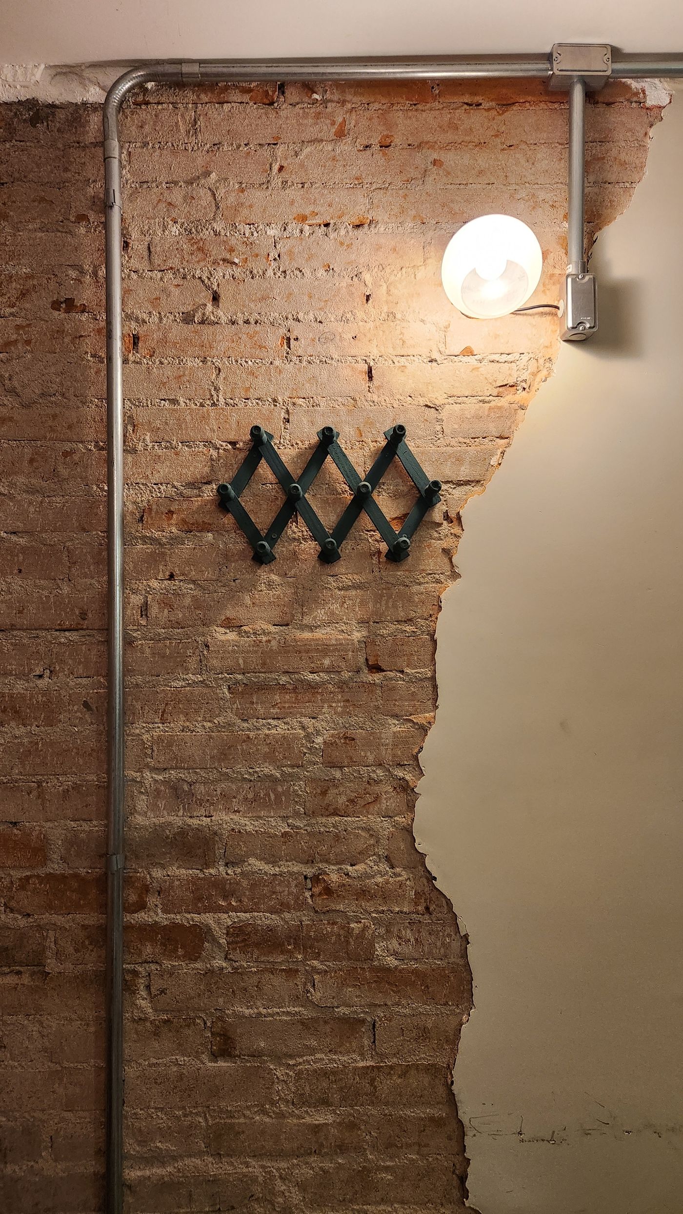 Exposed brick wall with a warm globe lamp