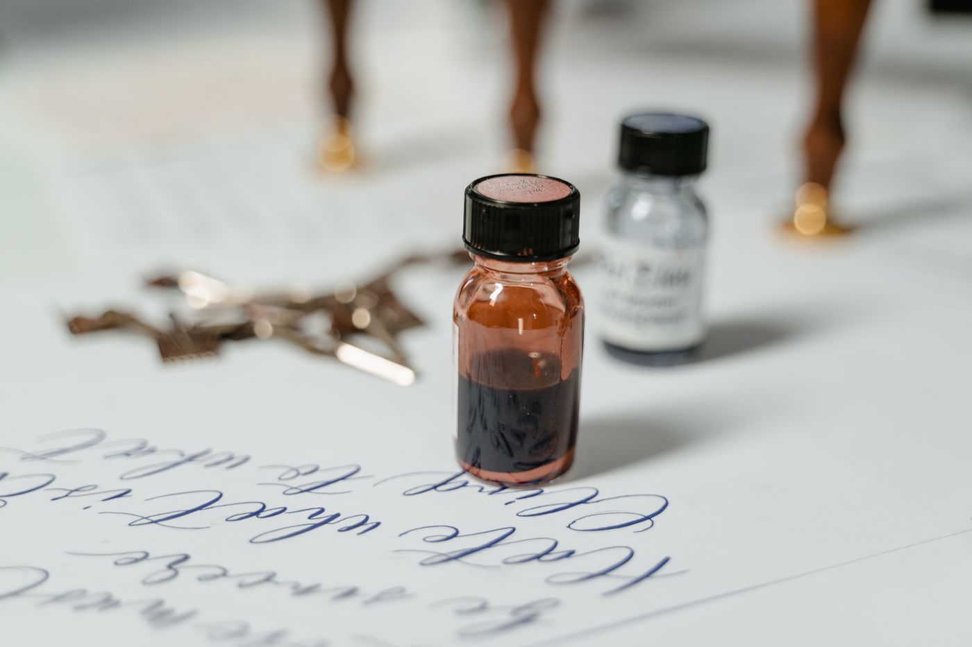 Ink bottles arranged as a still life on paper