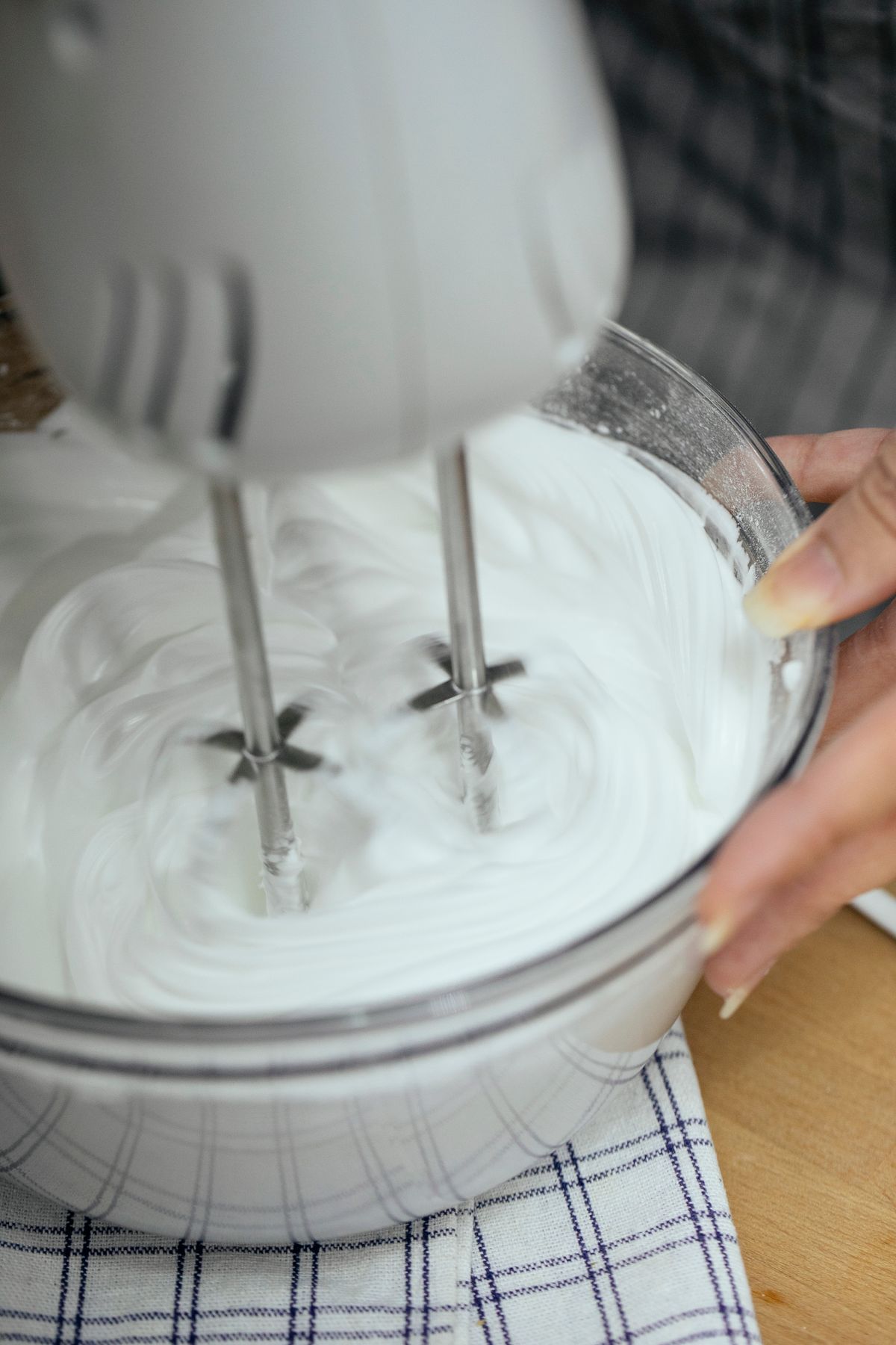 Whisking cream in a bowl by hand