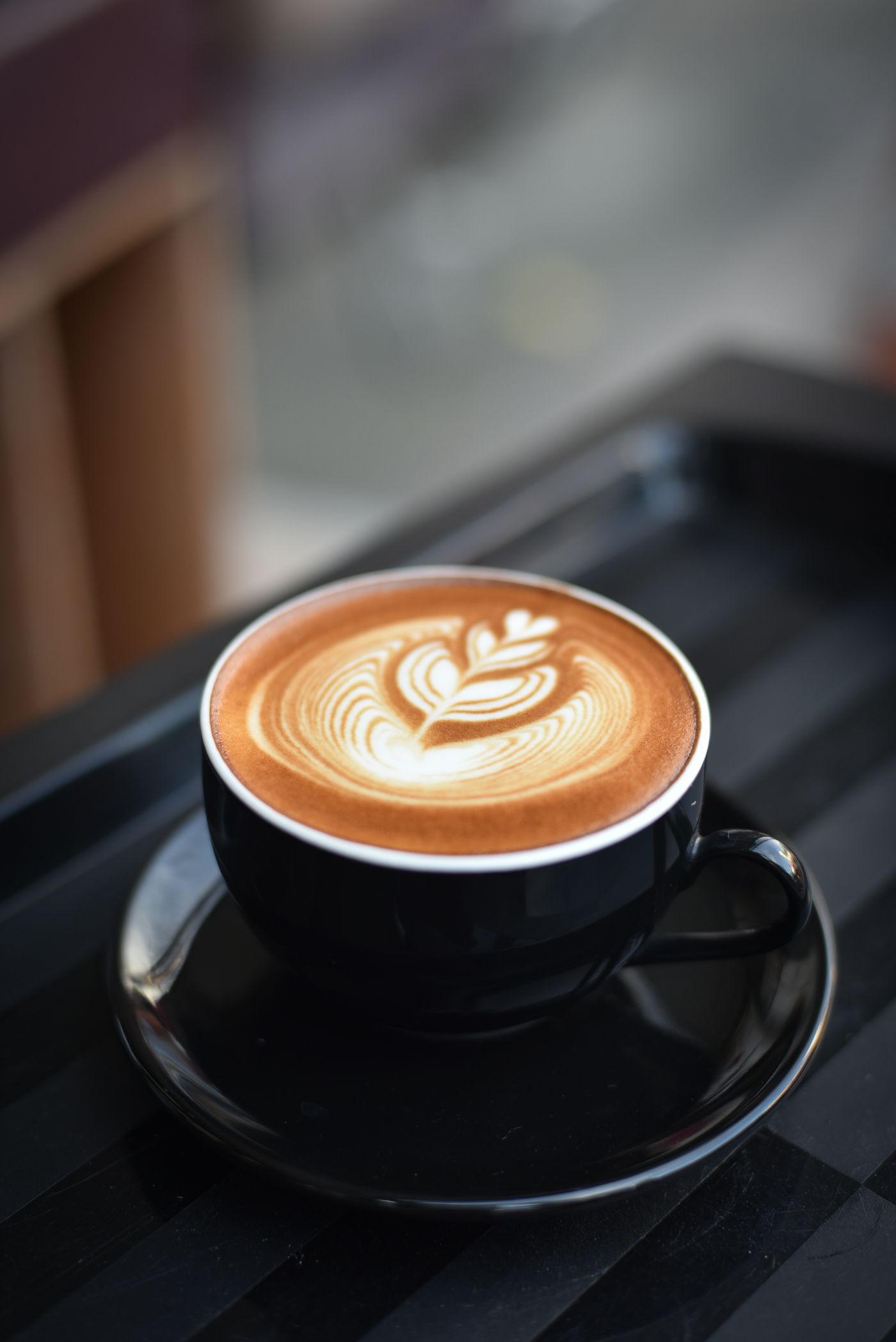 Latte art in a dark cup