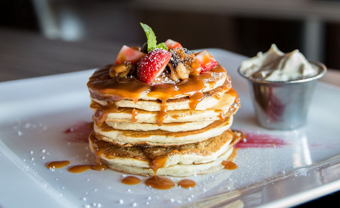 A plated sweet stack with fruit and caramel