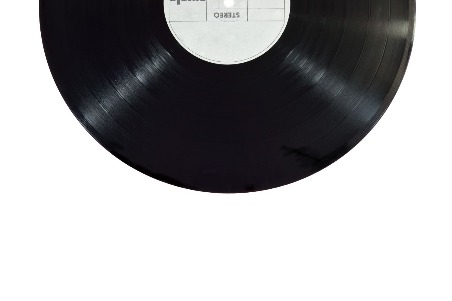 A vinyl record lifted from its sleeve