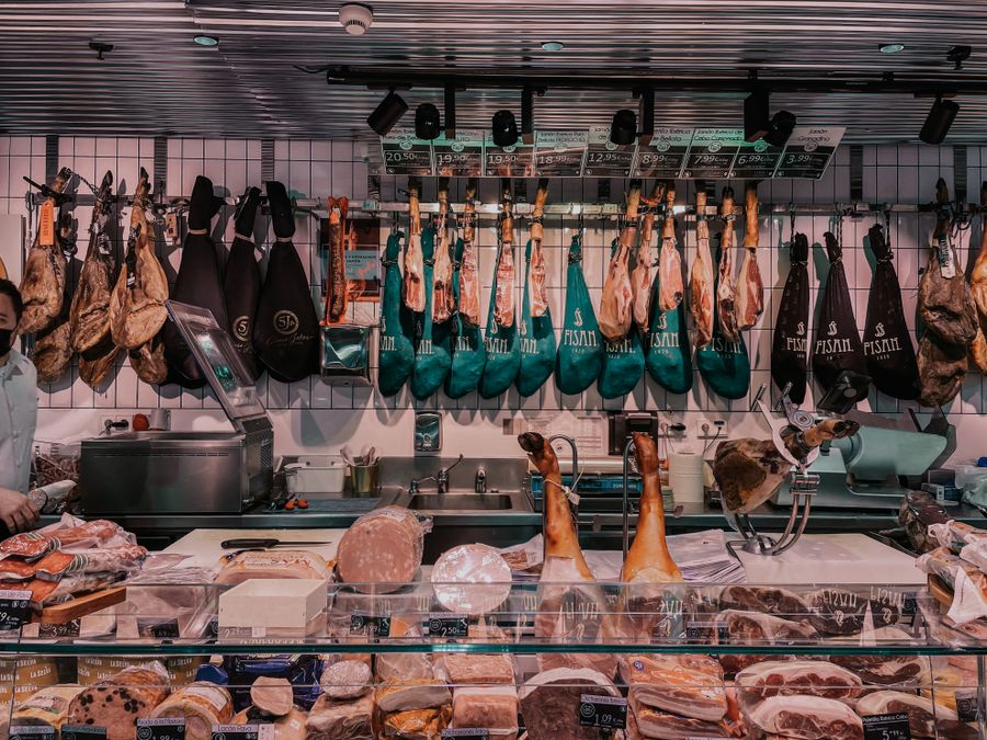 Italian deli counter hung with cured meats