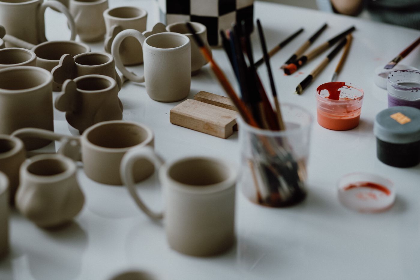 Pottery tools beside greenware ready to glaze
