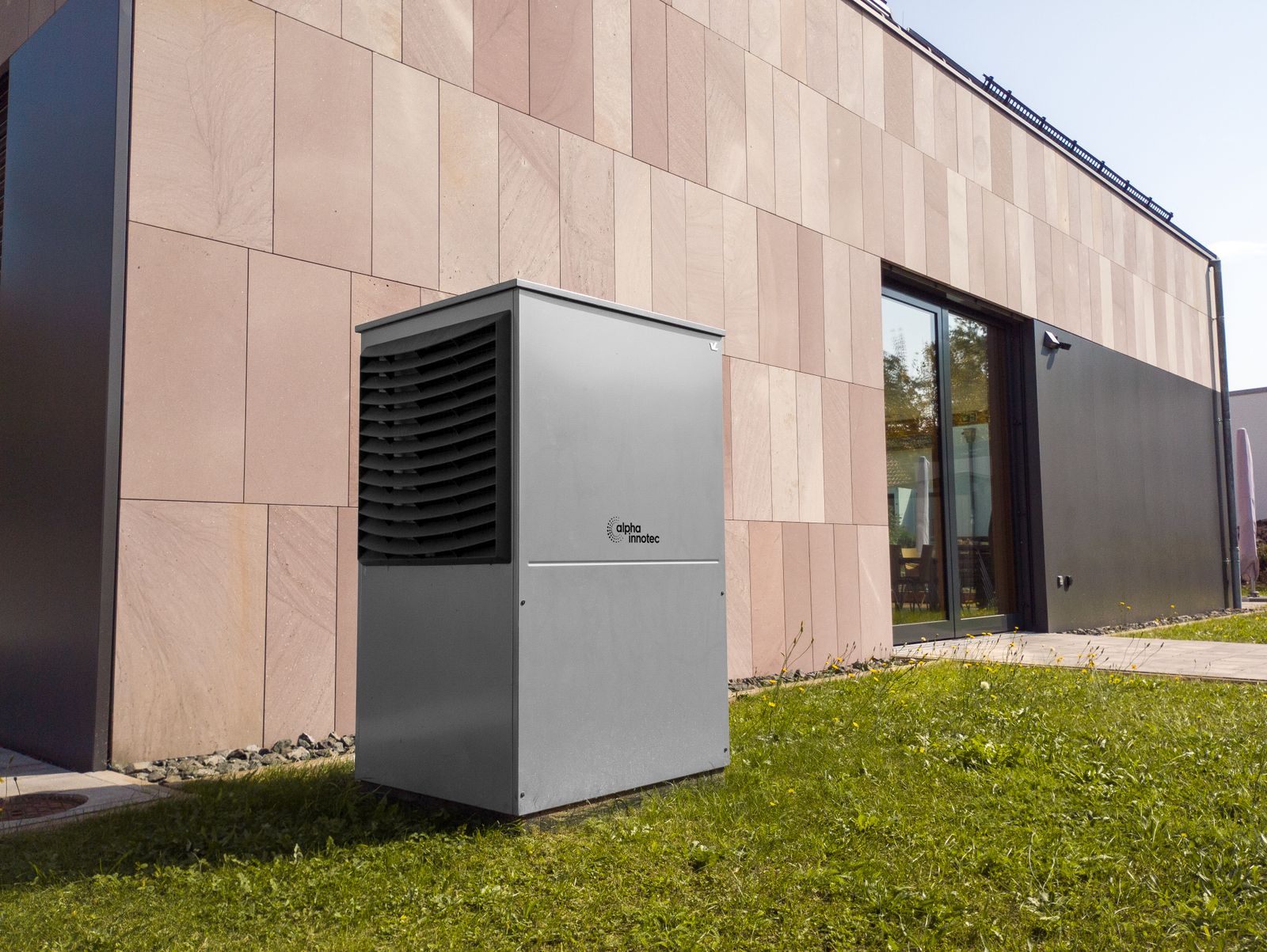 A modern outdoor heat pump beside a home