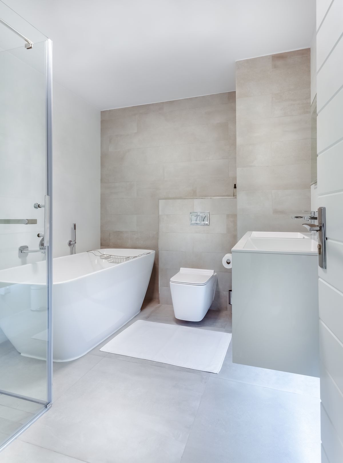 Bright white bathroom with freestanding tub and chrome taps