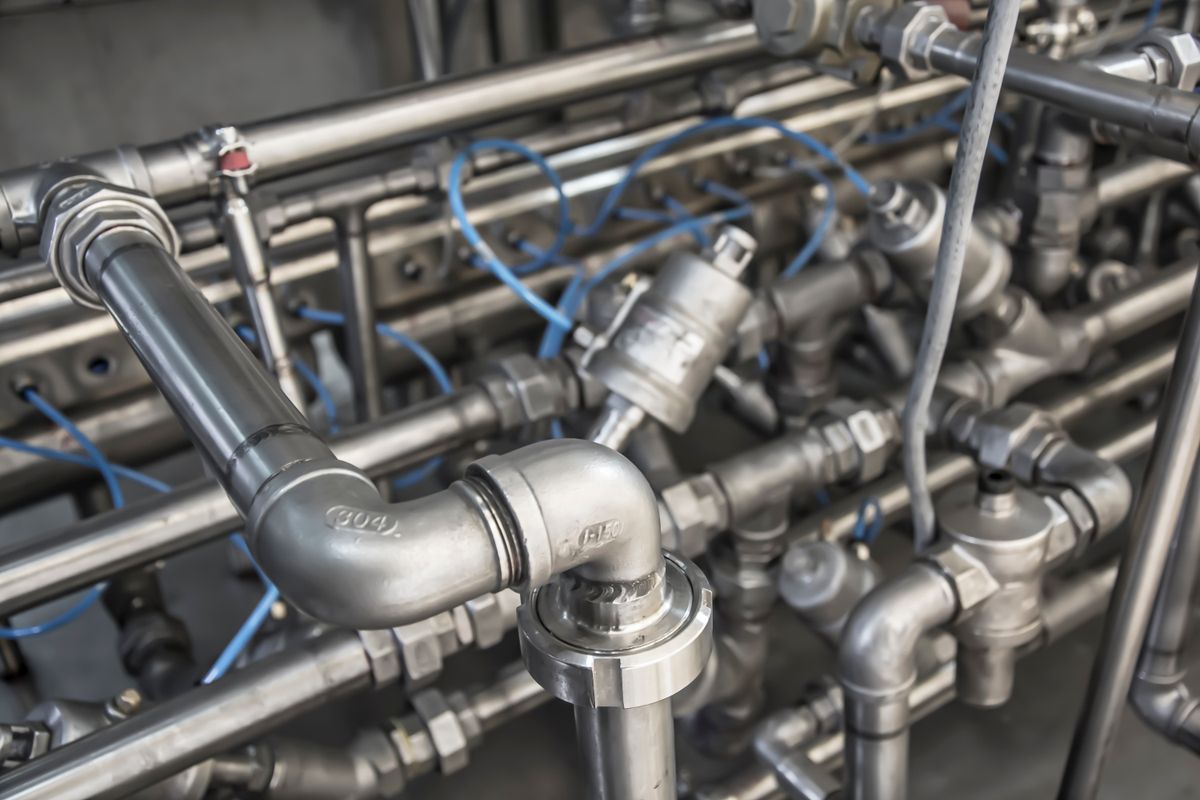 Close-up of stainless steel pipe fittings, elbows and valves