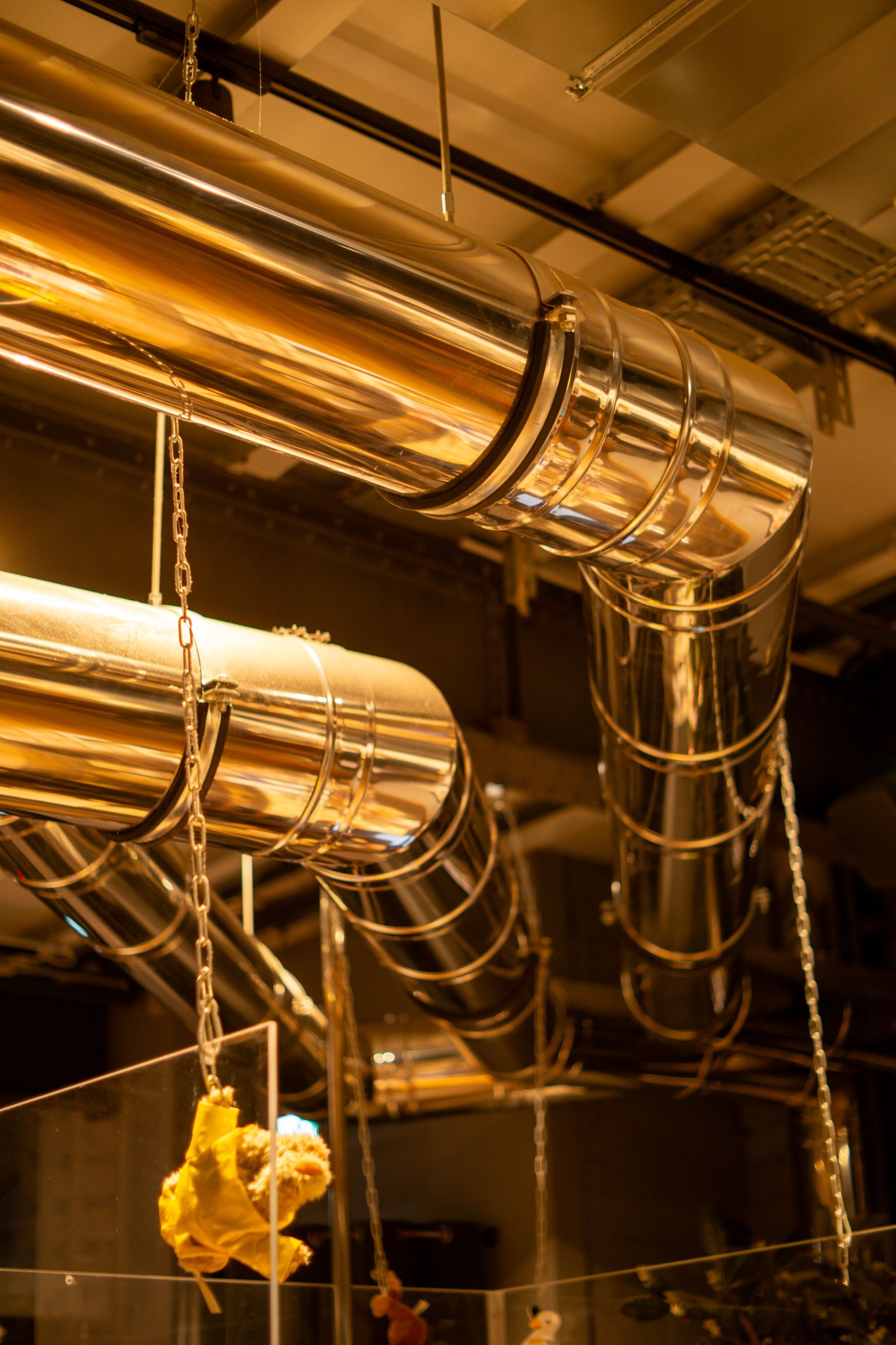 Polished metal ductwork running through a mechanical space