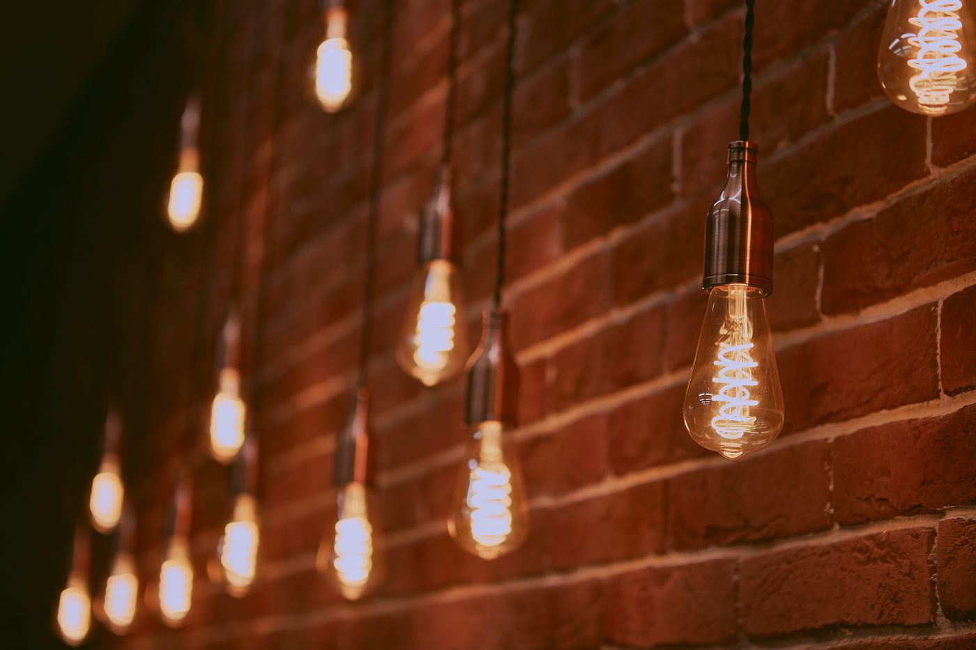 Warm Edison-style bulbs against brick