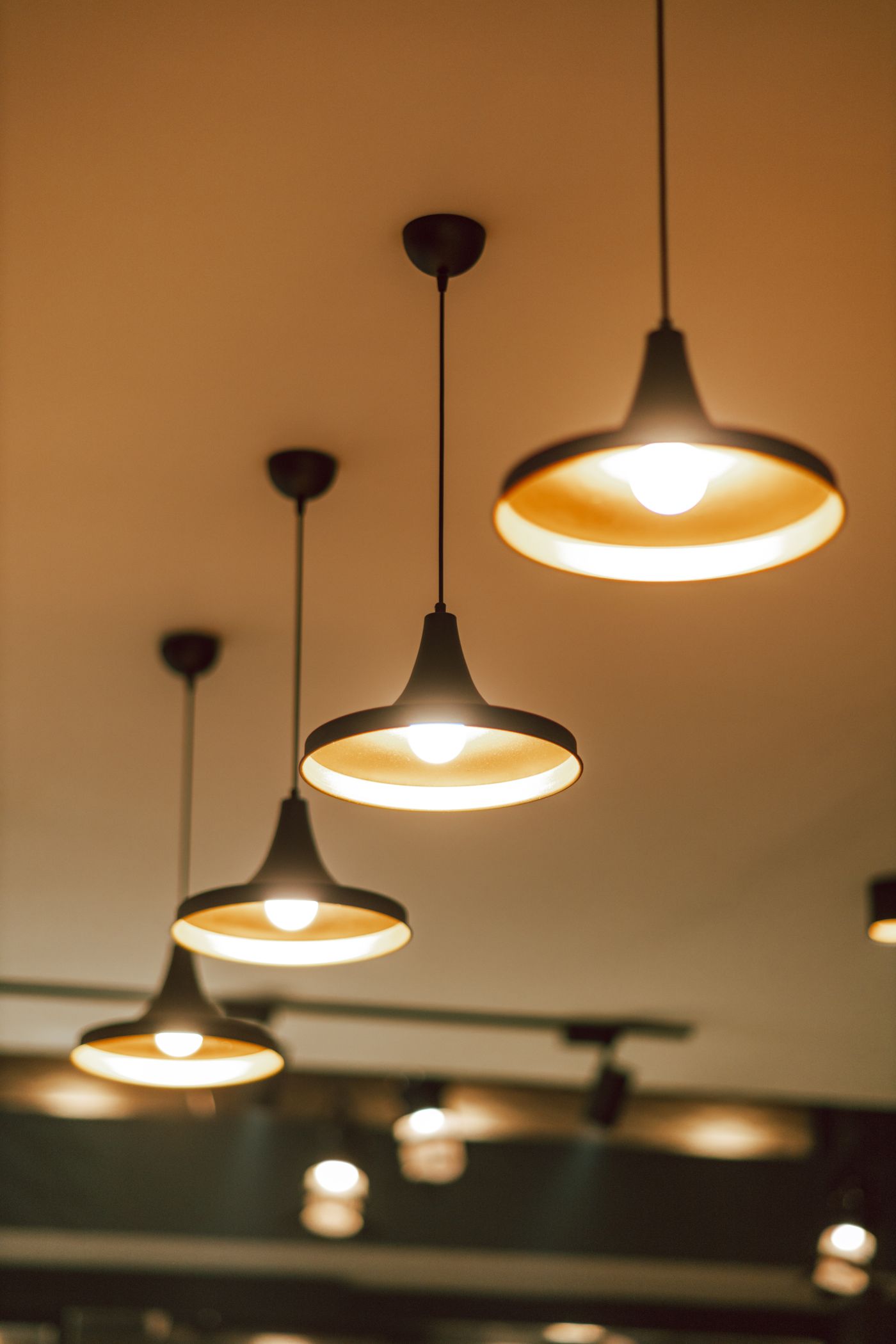 Warm pendant lights installed over a counter