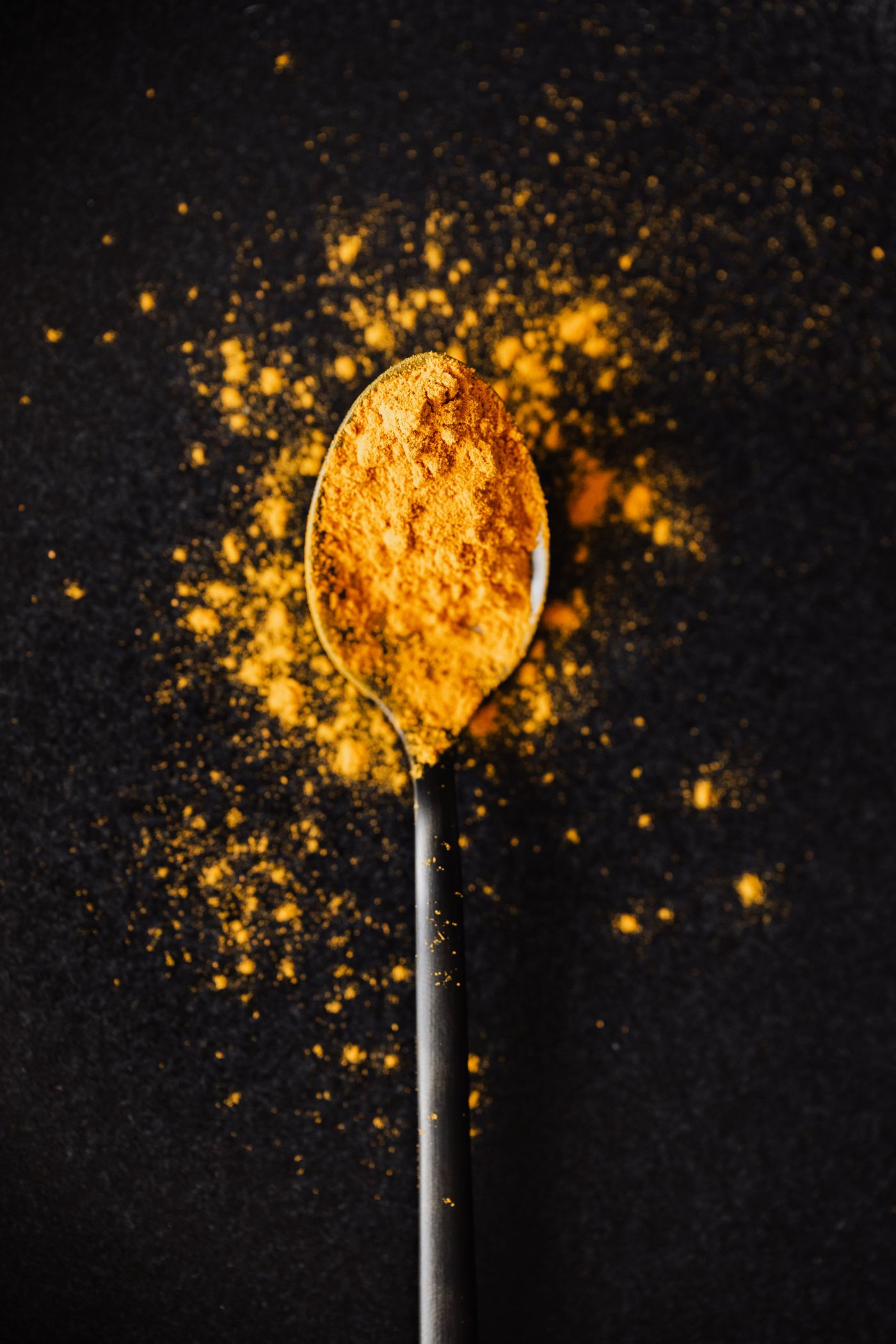 A scoop of bright turmeric powder