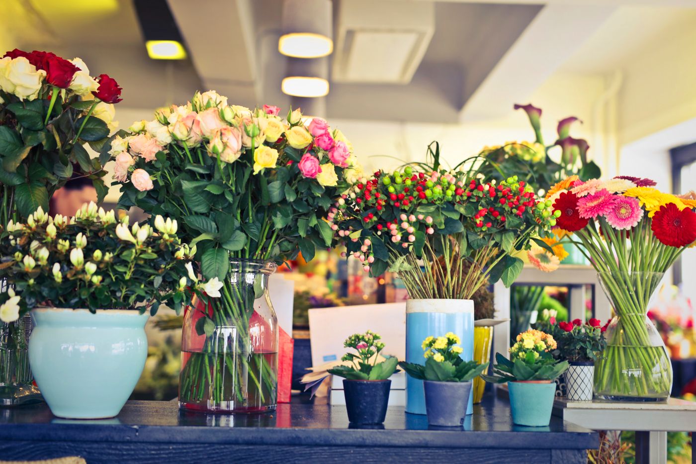 Fresh bouquets in vases on the shop counter