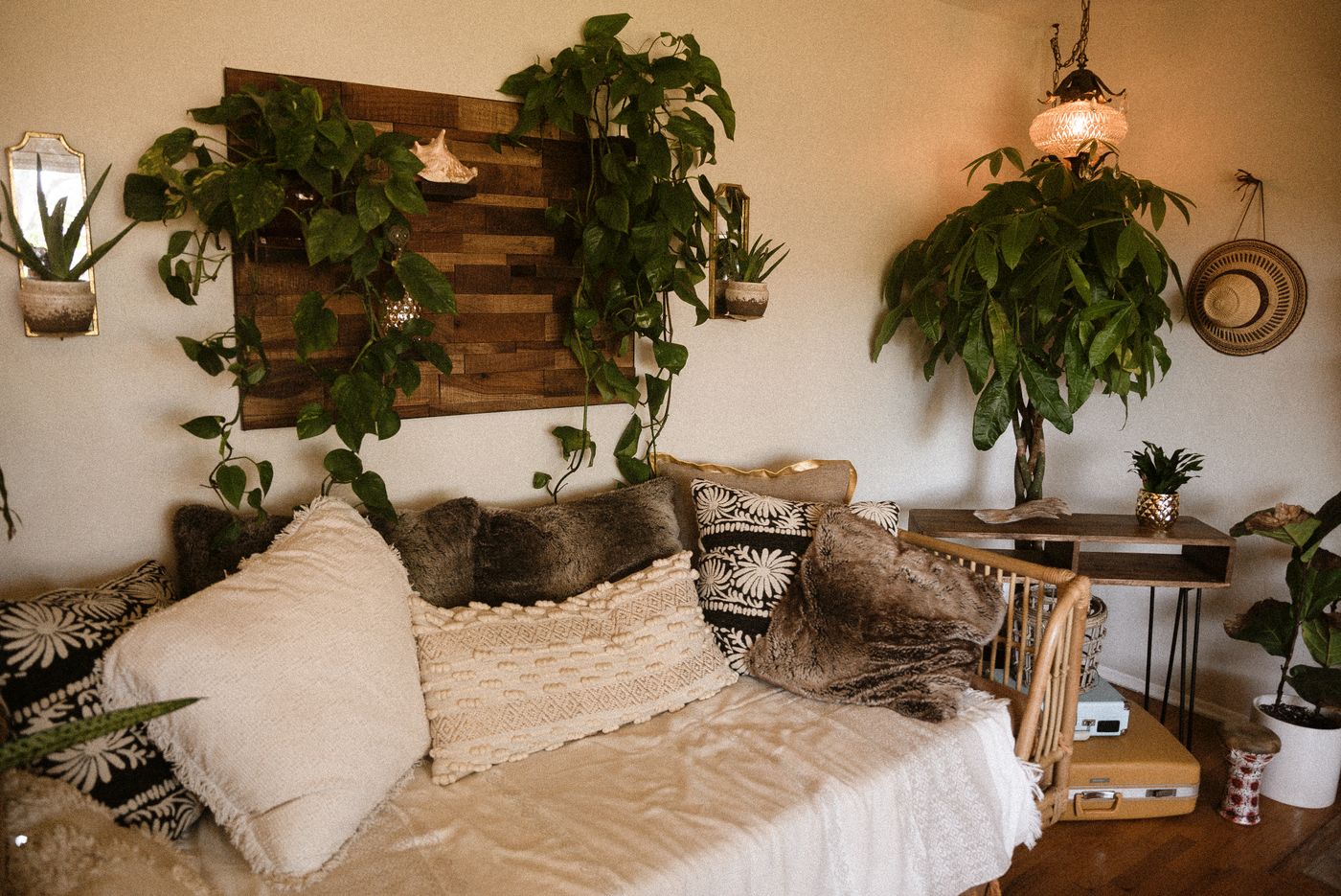The styled home corner of the shop — pampas, leather chairs, books and brass shelves