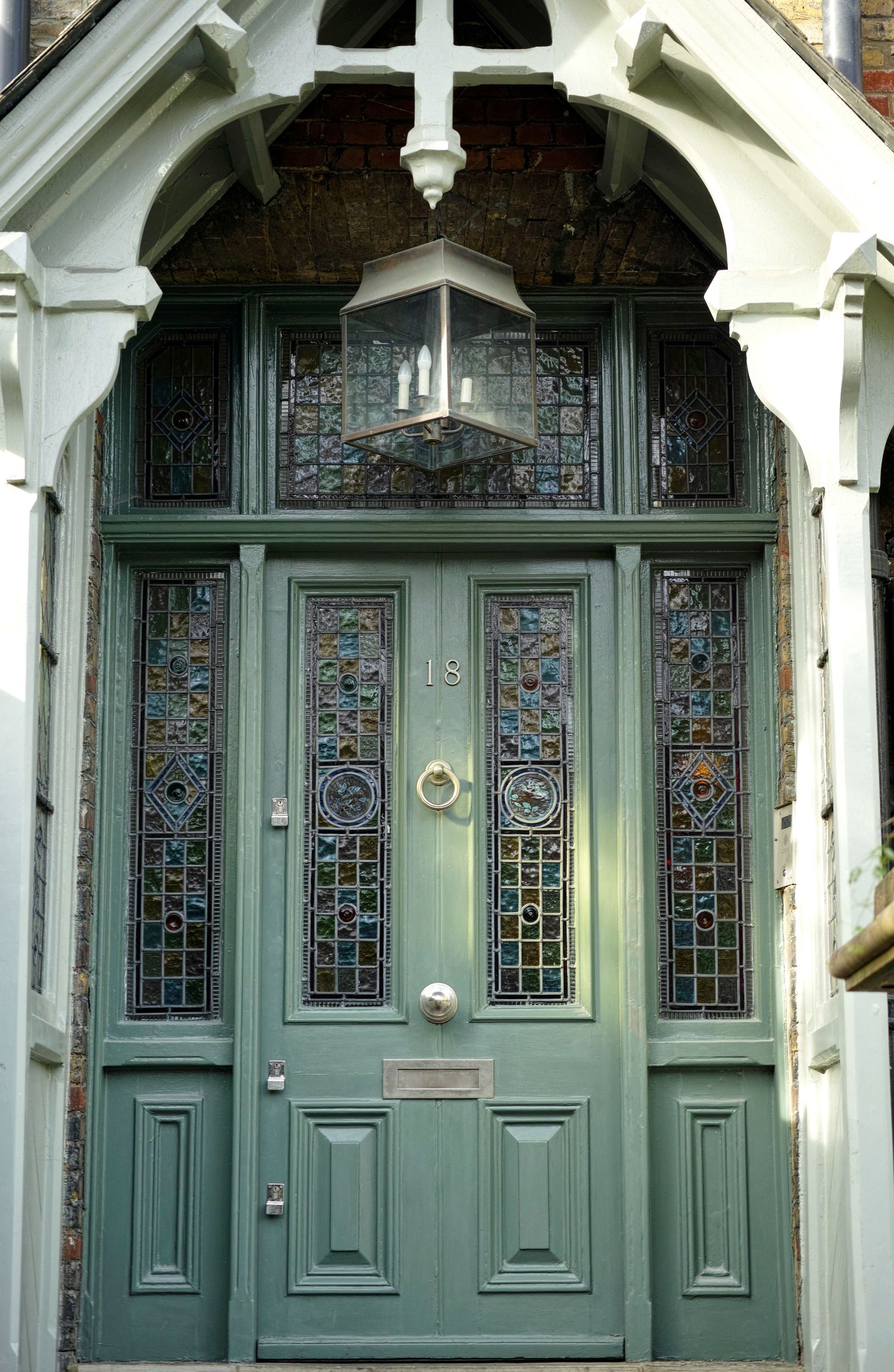 A heritage green door with brass