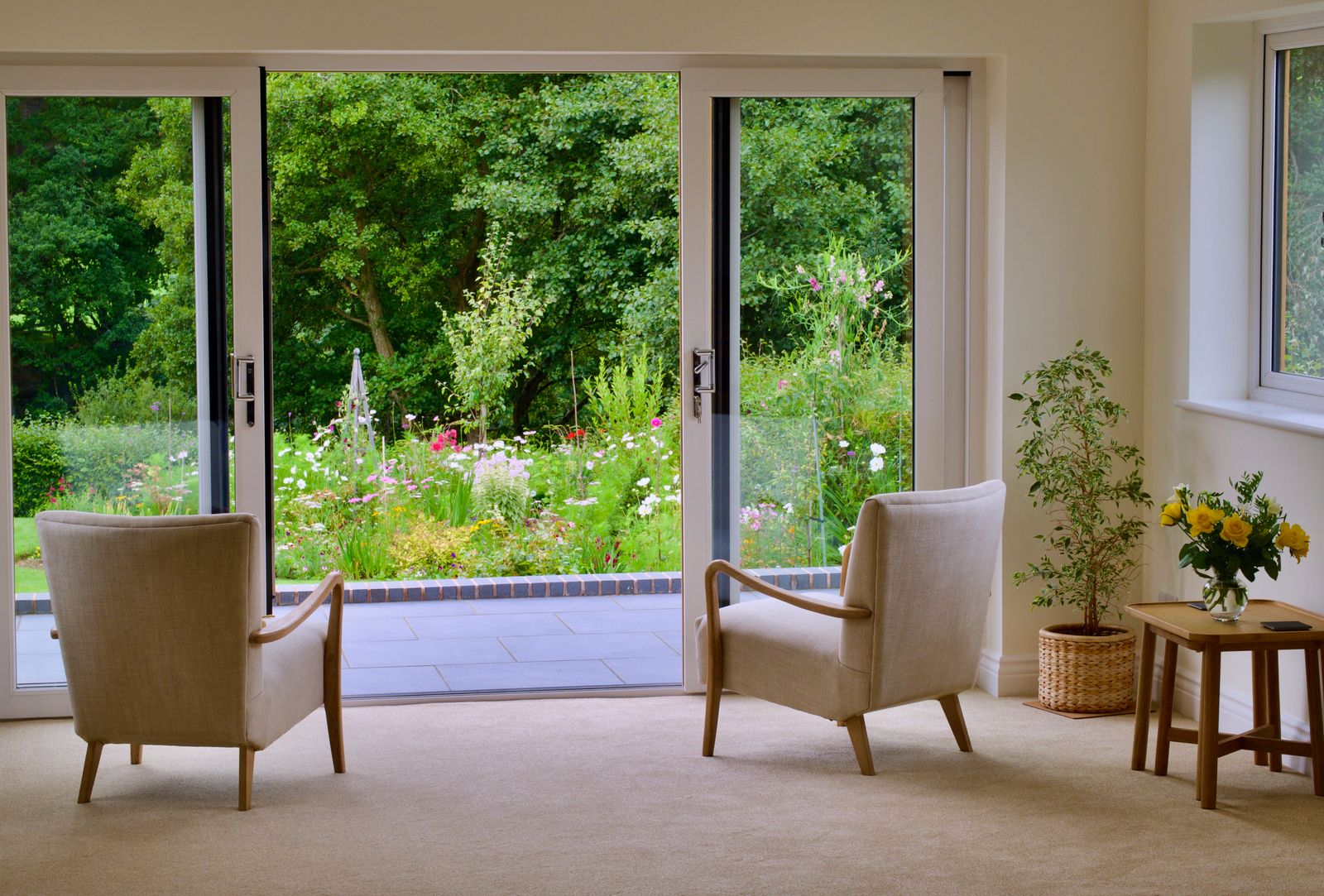 A sliding patio glass door opening to a garden