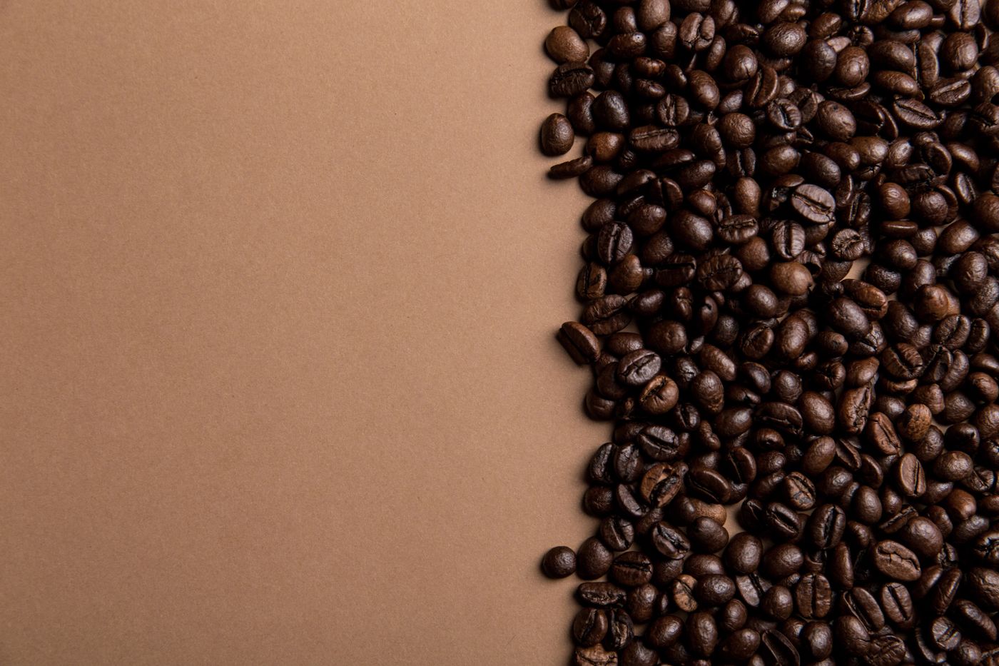 Espresso cup beside roasted beans