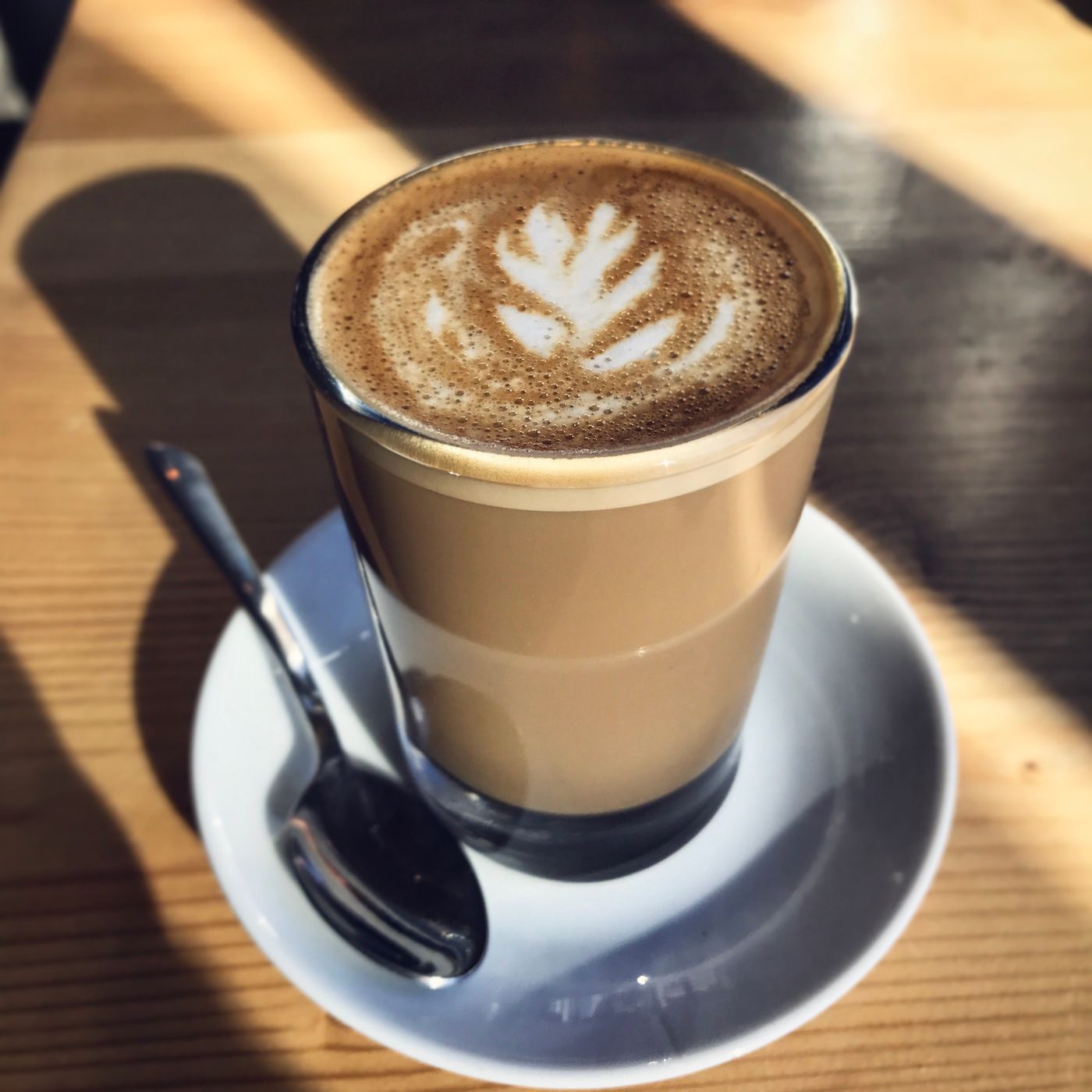A latte in a wide ceramic cup