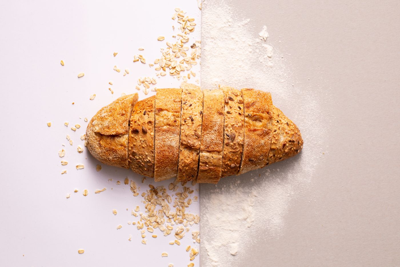 A gluten-free loaf sliced clean on a pale surface