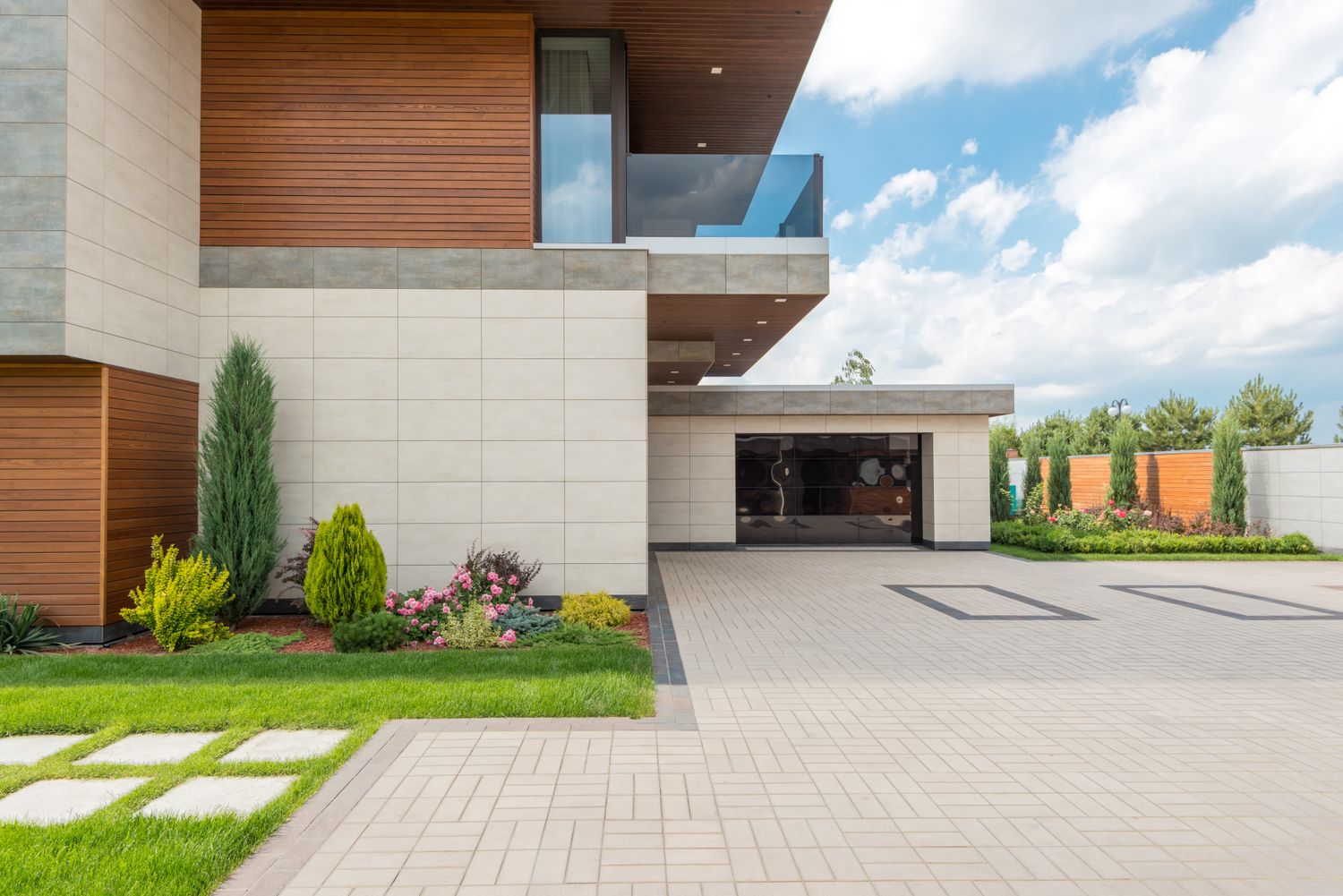 A modern home with garage and paved driveway