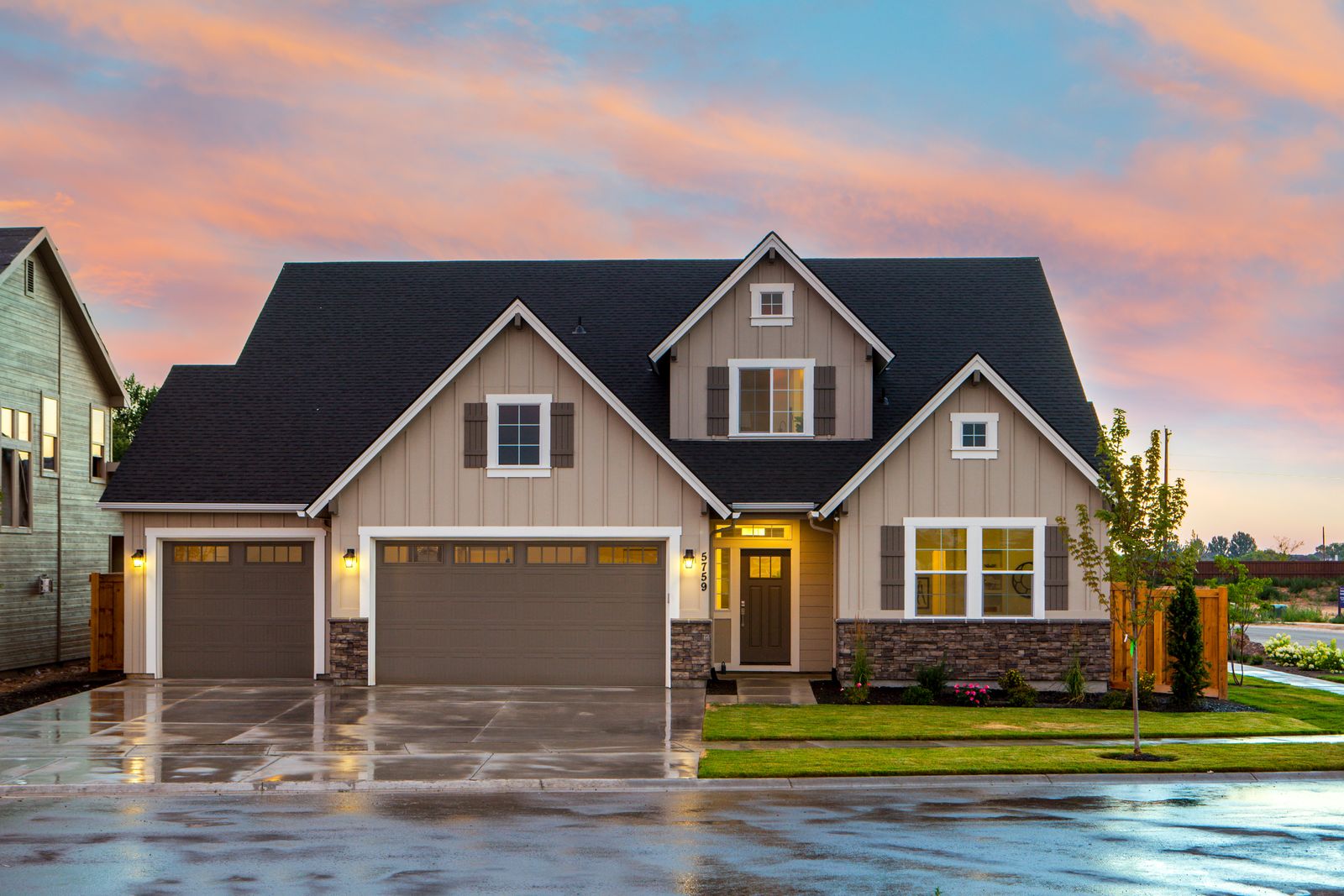 A home with two garage doors at dusk