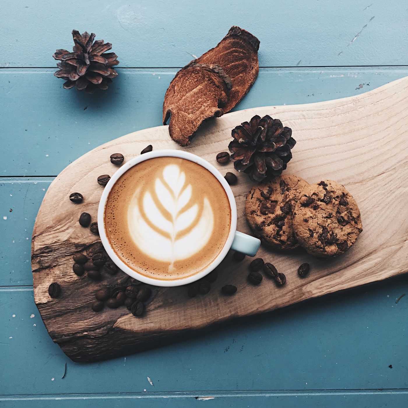 Latte on a wooden board with cookies