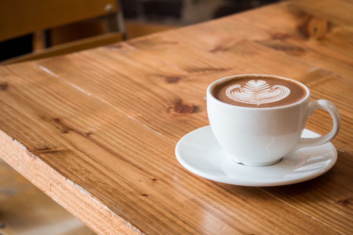 Latte on a wooden cafe table