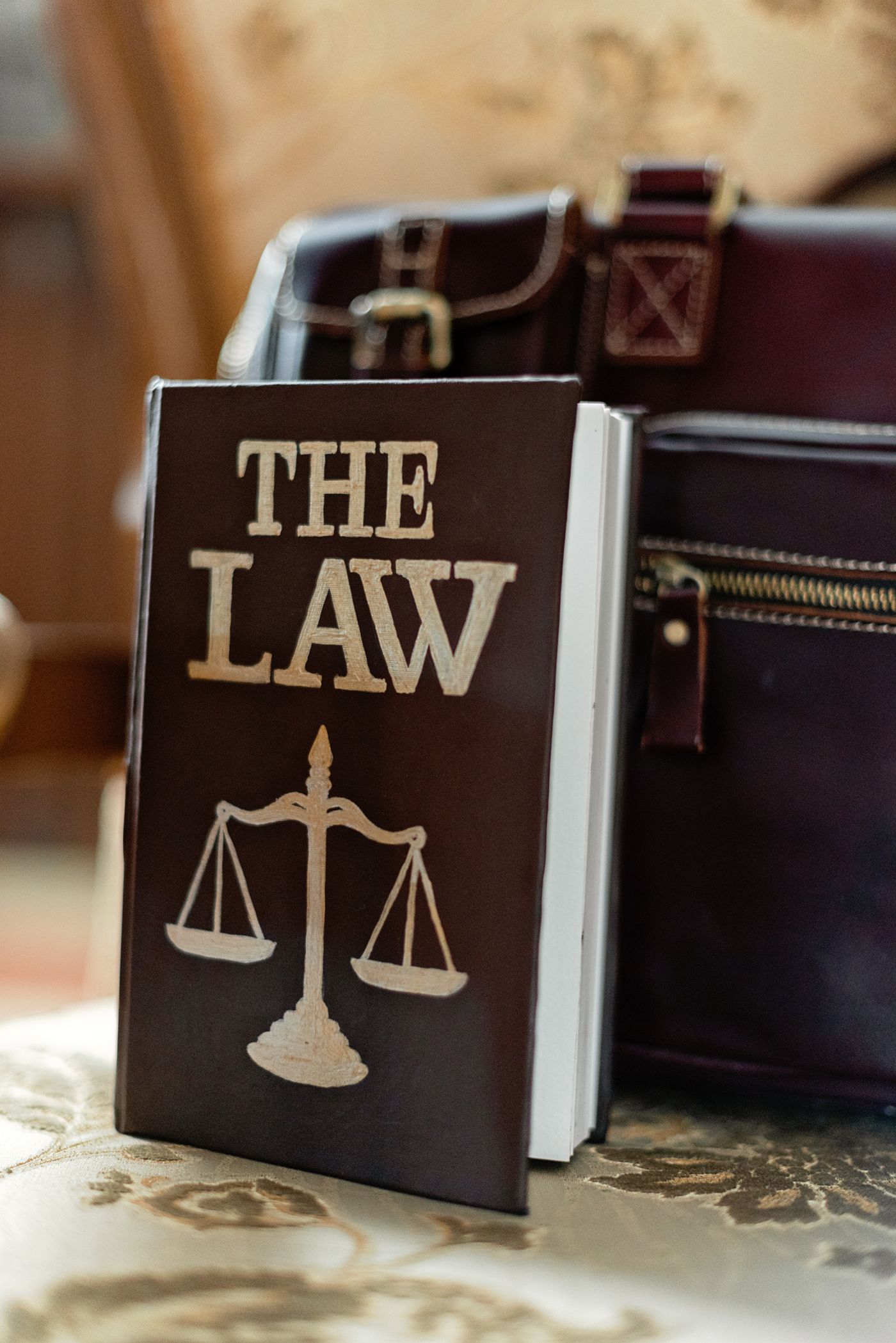 A law book and leather briefcase on a desk