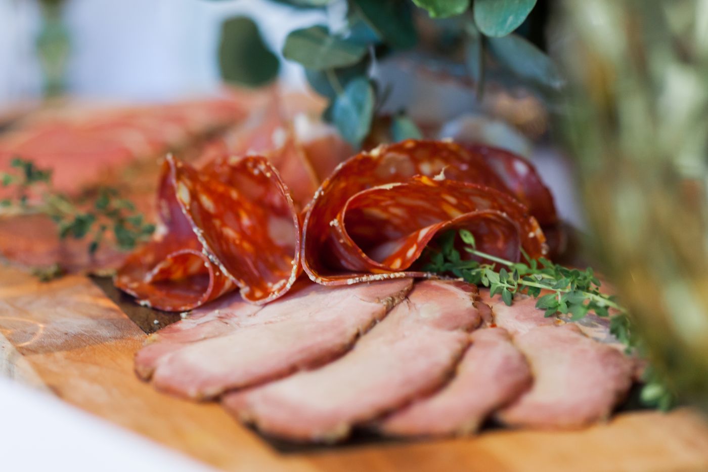 Sliced house Kolbassa and cured meats on the board