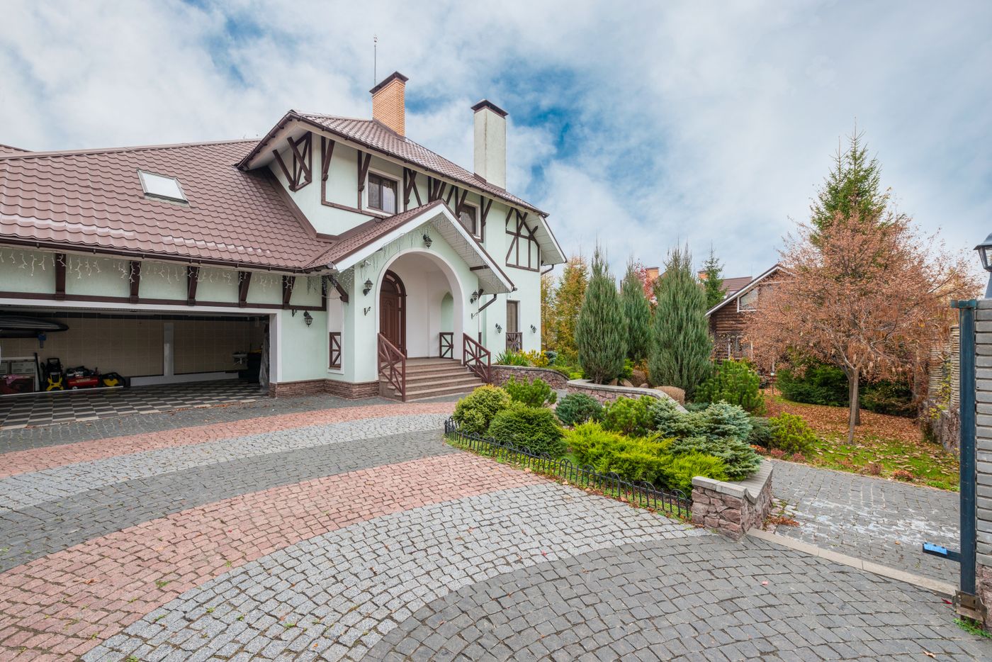 Clean brick driveway in front of a home