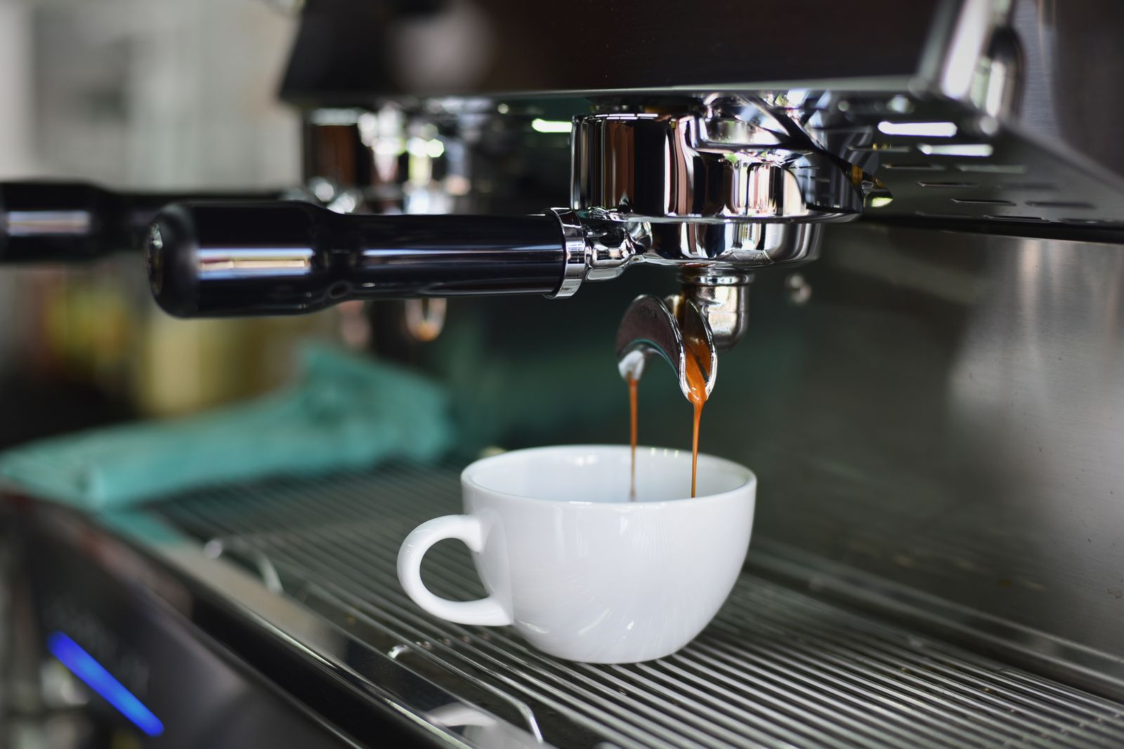 Espresso pouring from a machine into a cup