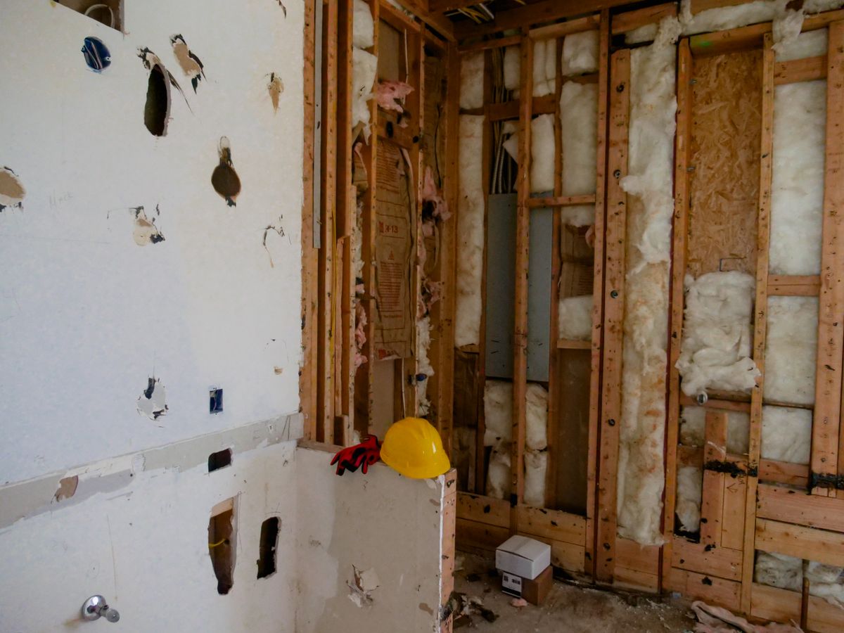Wall stripped to studs during water-damage repair