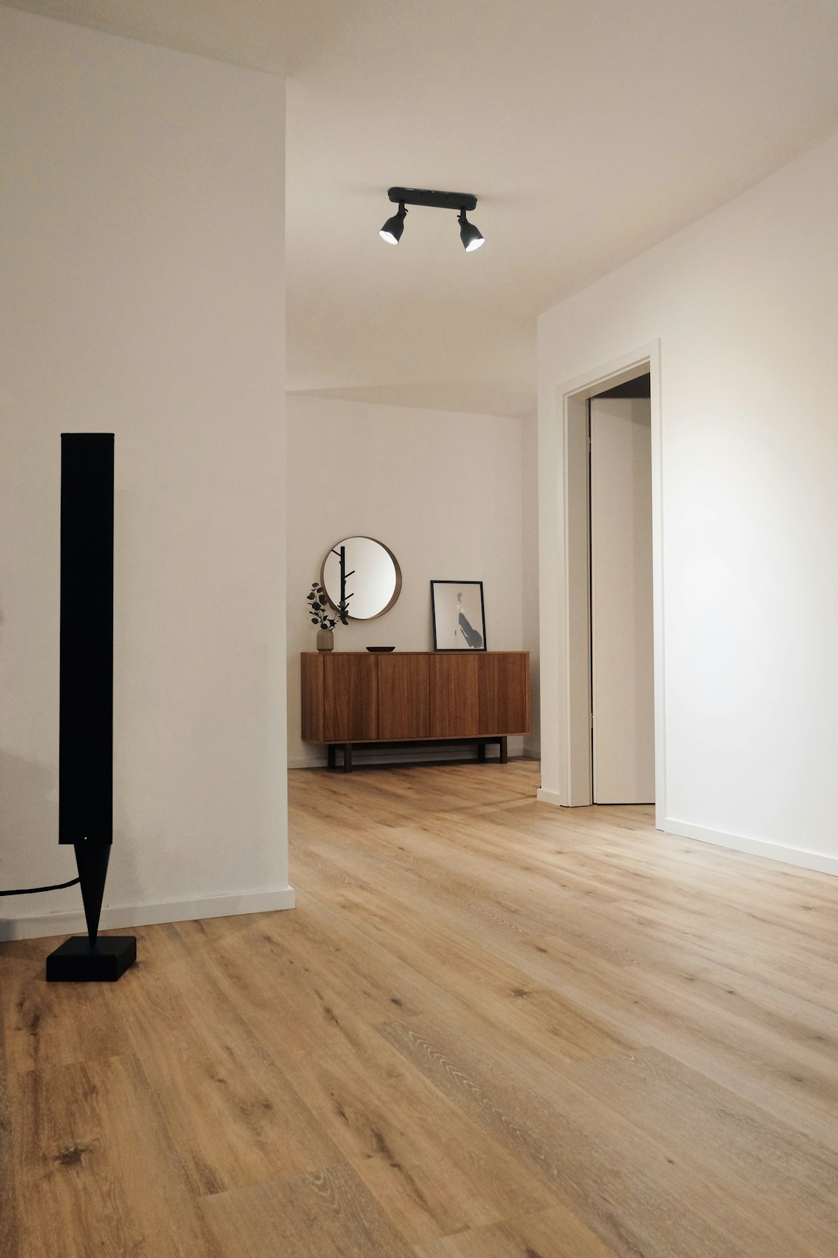 A room with newly installed wide-plank hardwood flooring
