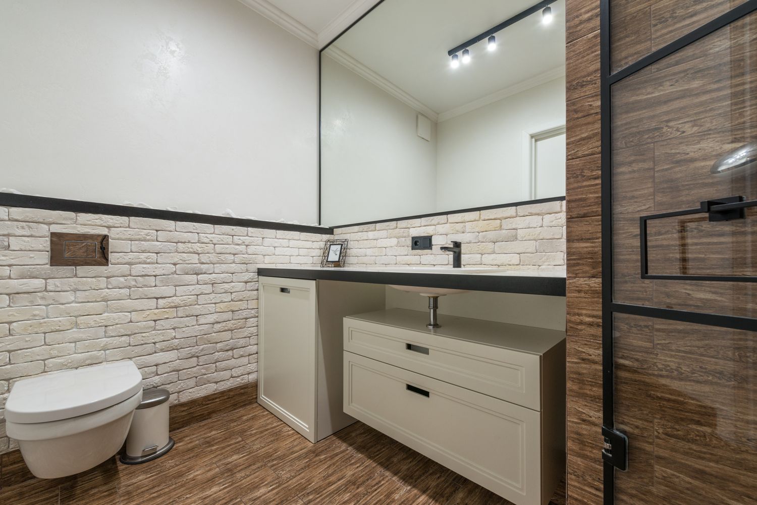 A renovated tiled wet area with large-format tile and glass