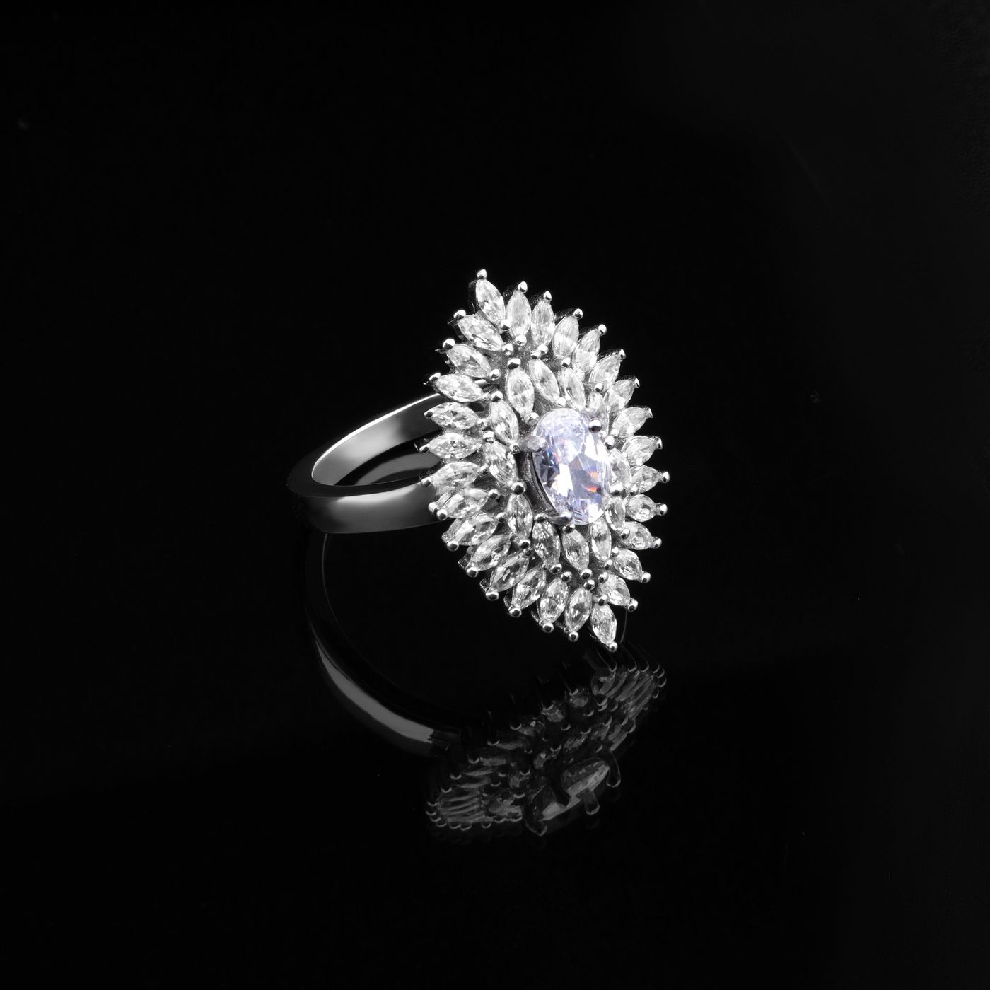 A marquise cluster ring against black