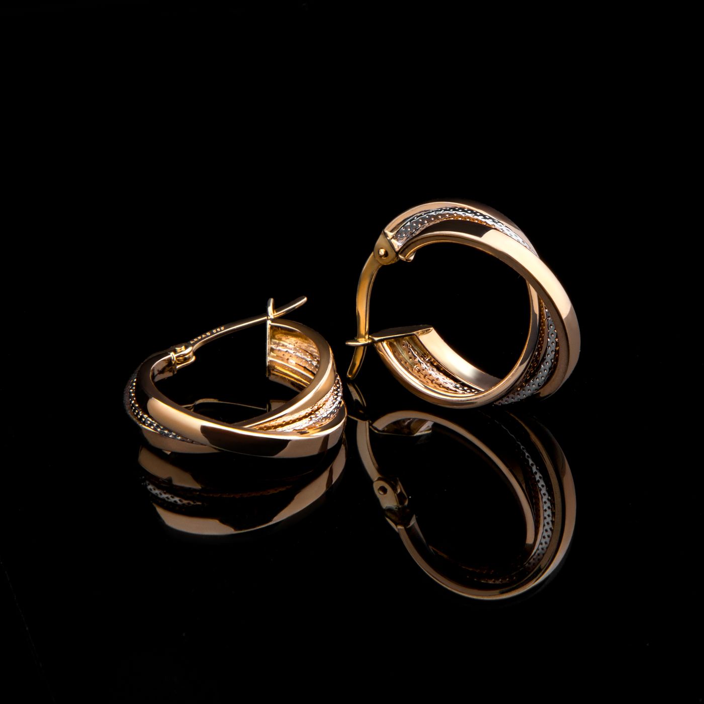 Gold hoop earrings on black