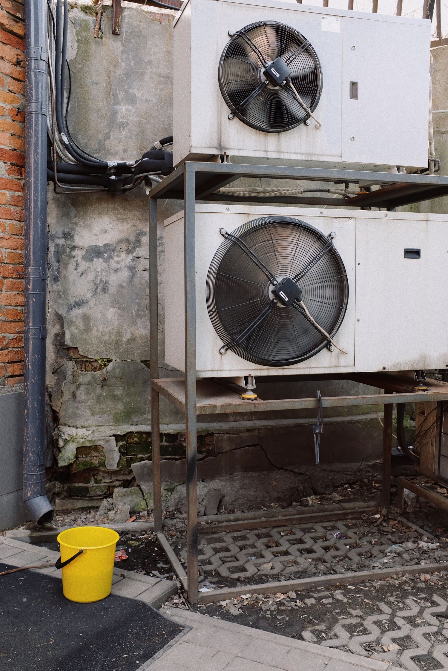 Air-conditioning compressor units mounted on a steel frame outdoors