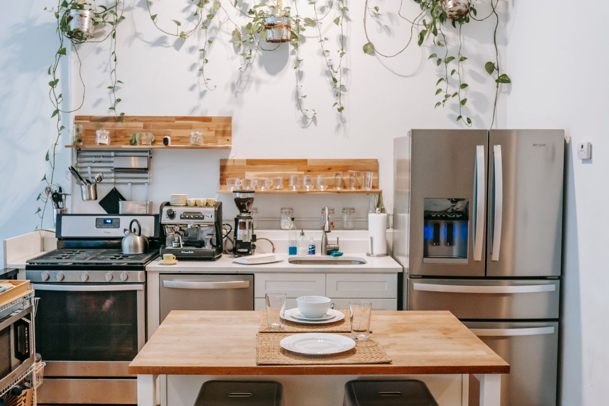 A kitchen with a built-in dishwasher and range