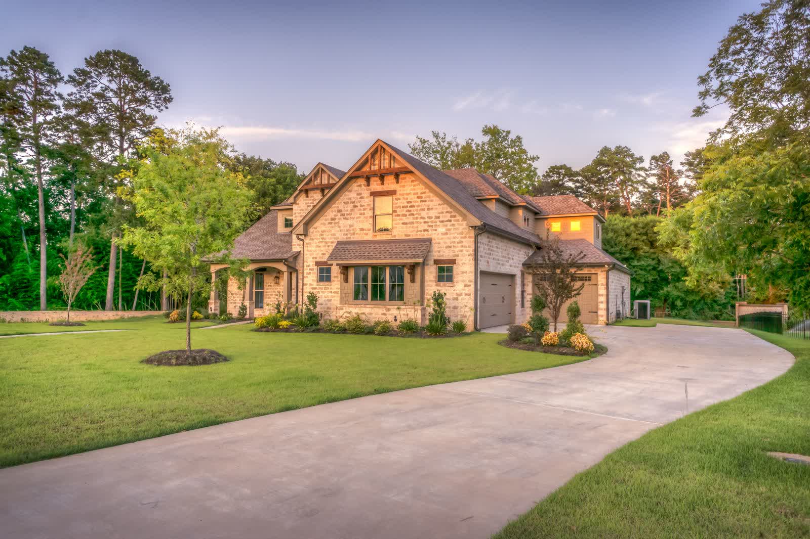 A home wrapped in glass at dusk