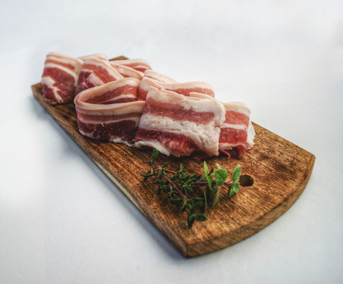 Cured bacon and meats on a wooden board