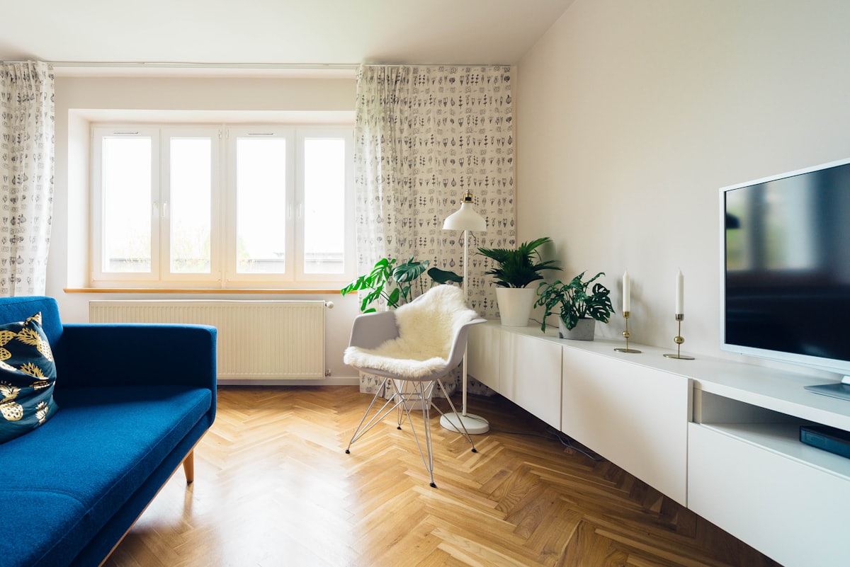 A living room dressed with soft window coverings