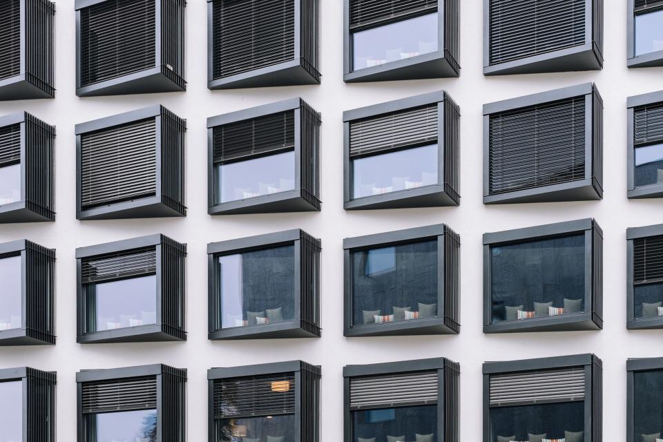 A facade of windows dressed in venetian blinds