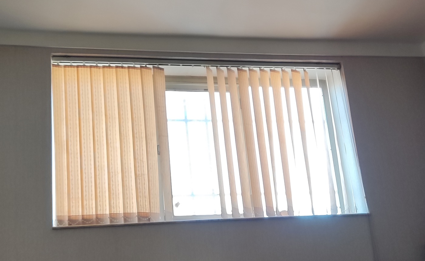 A window fitted with vertical blinds